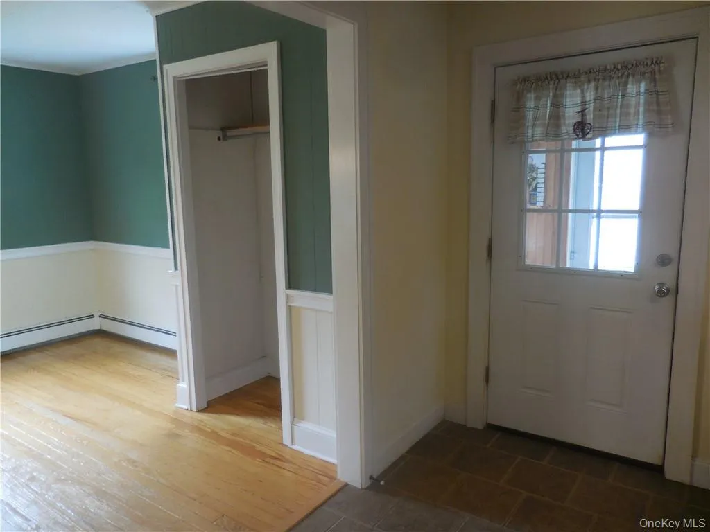 Doorway to outside featuring hardwood / wood-style flooring Doorway to outside featuring hardwood / wood-style flooring
