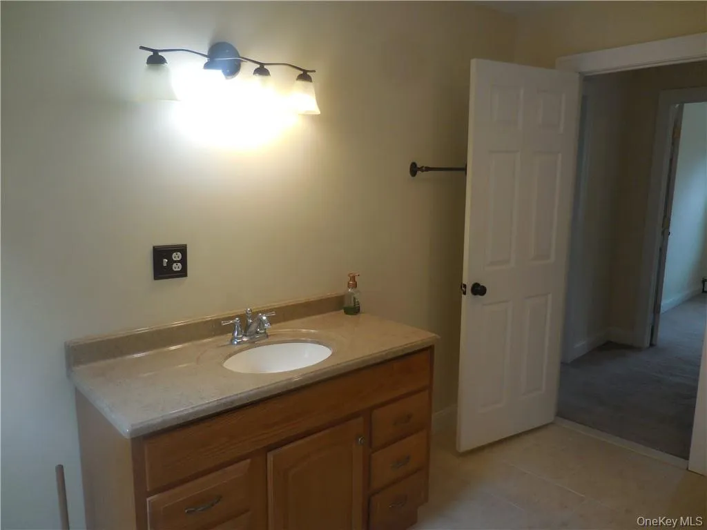 Bathroom with tile patterned flooring and vanity Bathroom with tile patterned flooring and vanity