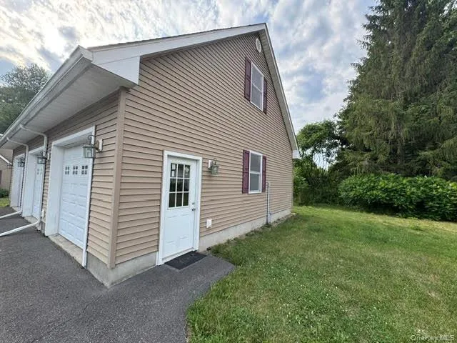 View of the large garage with the side door. View of the large garage with the side door.