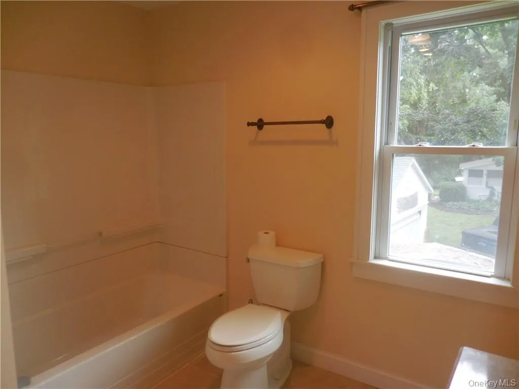 Bathroom featuring separate shower and tub, toilet, and tile patterned floors Bathroom featuring separate shower and tub, toilet, and tile patterned floors