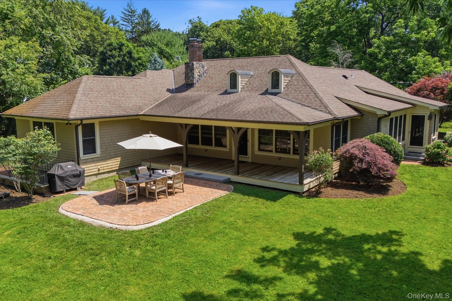 Covered rear porch overlooking the expansive backyard and stone patio. Covered rear porch overlooking the expansive backyard and stone patio.