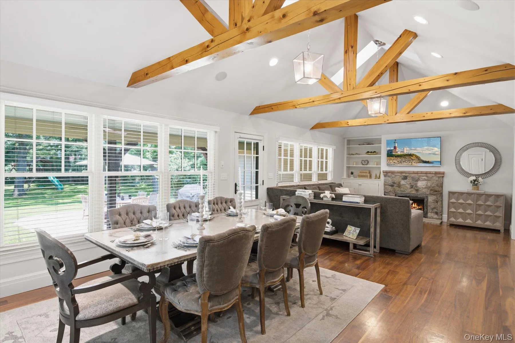 Open-concept dining area with soaring ceilings and wood beams. Open-concept dining area with soaring ceilings and wood beams.