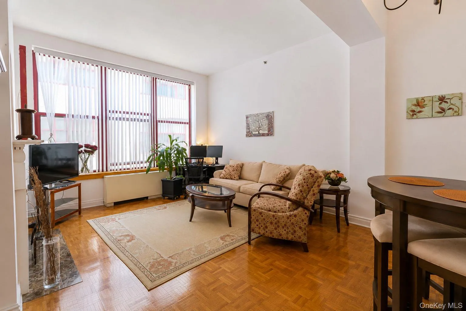 Spacious living room with oversized windows and parquet floors Spacious living room with oversized windows and parquet floors