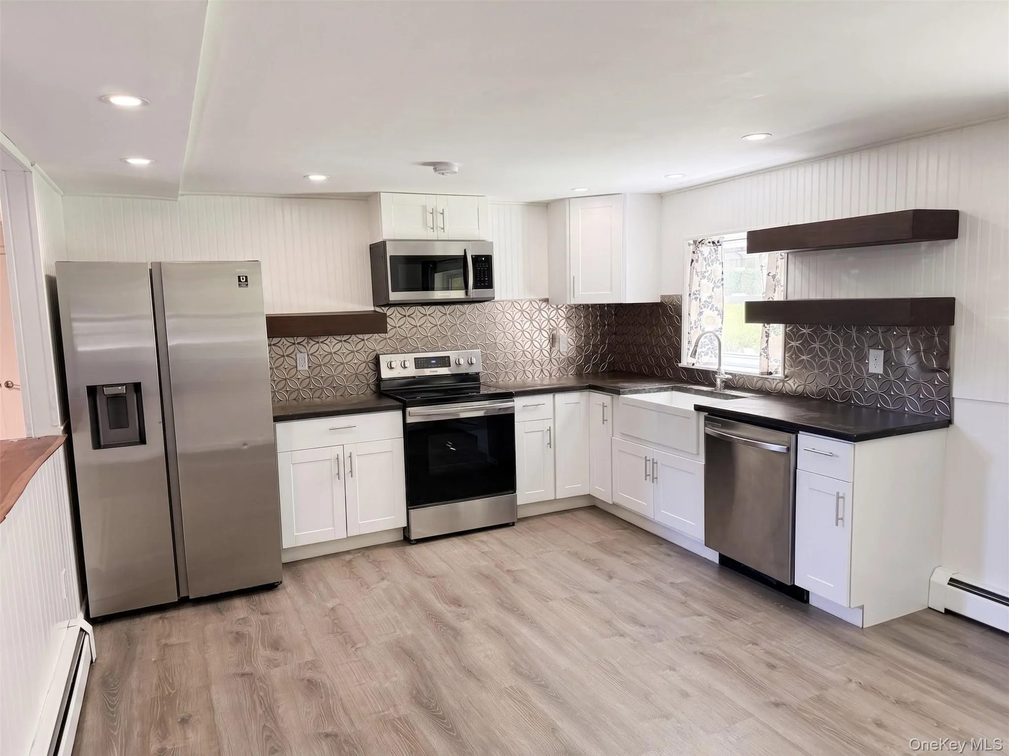Kitchen featuring stainless steel appliances, ample cabinetry, and generous counter space. Kitchen featuring stainless steel appliances, ample cabinetry, and generous counter space.