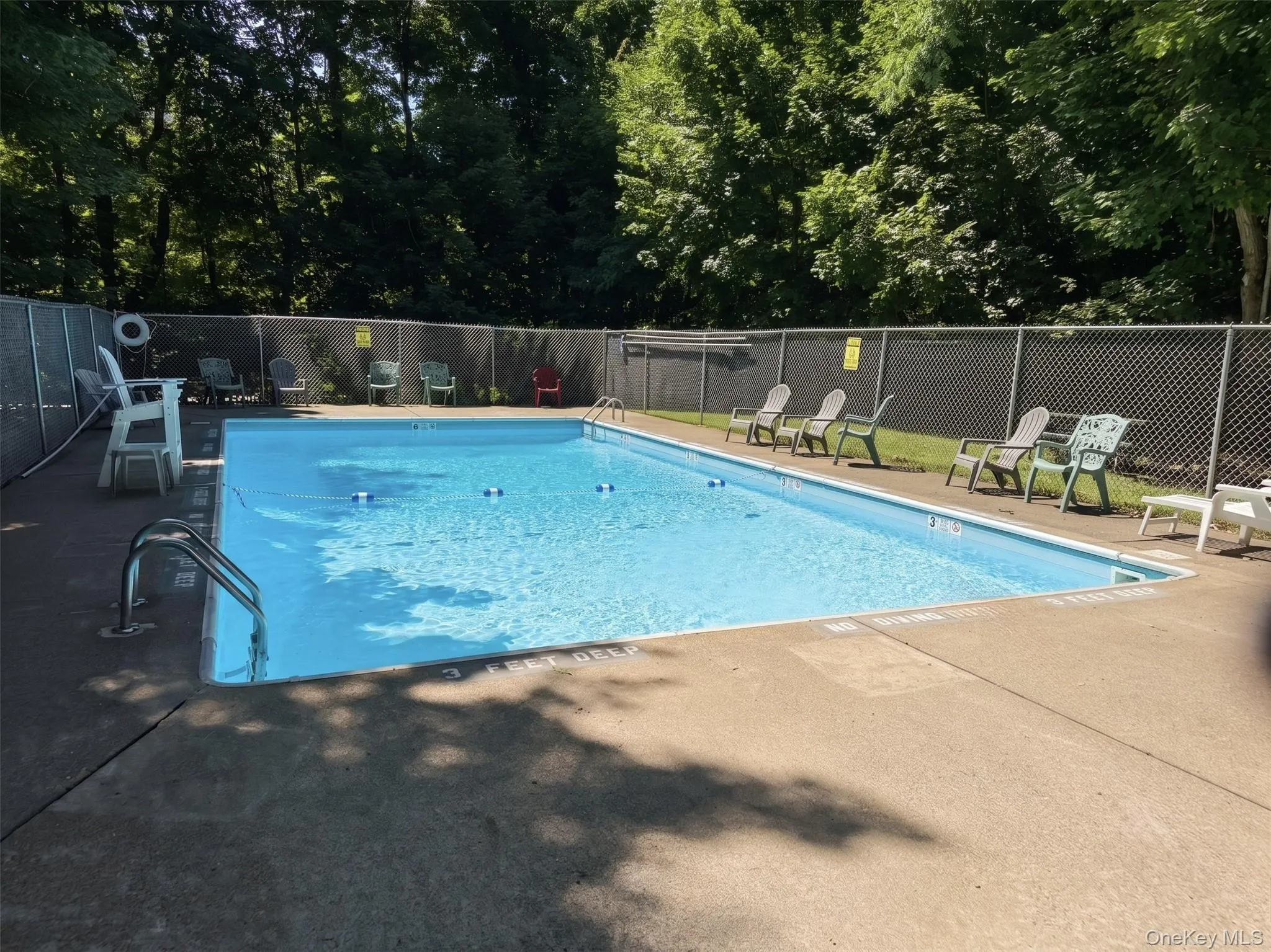 Community pool with lifeguard on duty. Community pool with lifeguard on duty.
