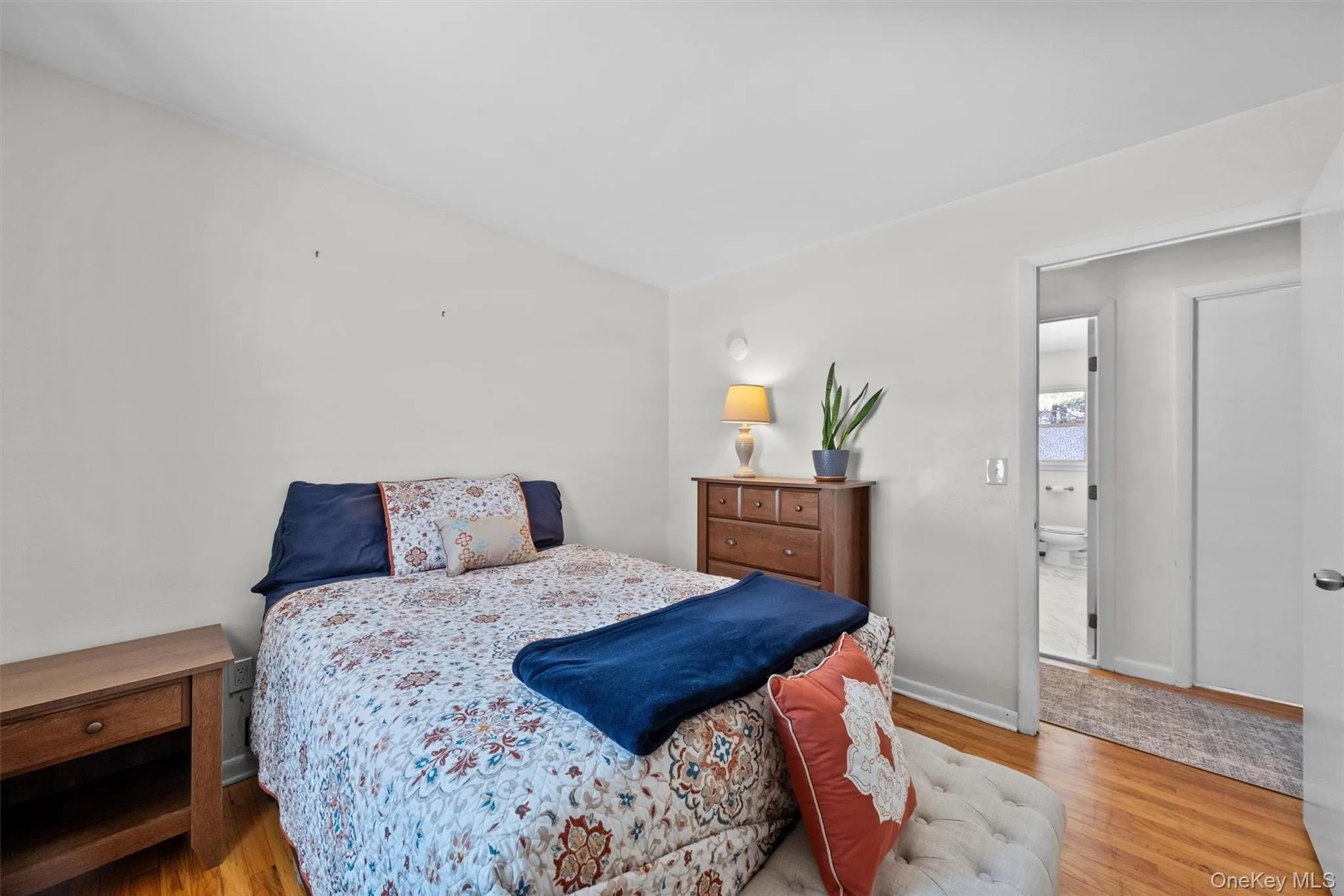 Bedroom featuring light wood-style floors and baseboards Bedroom featuring light wood-style floors and baseboards