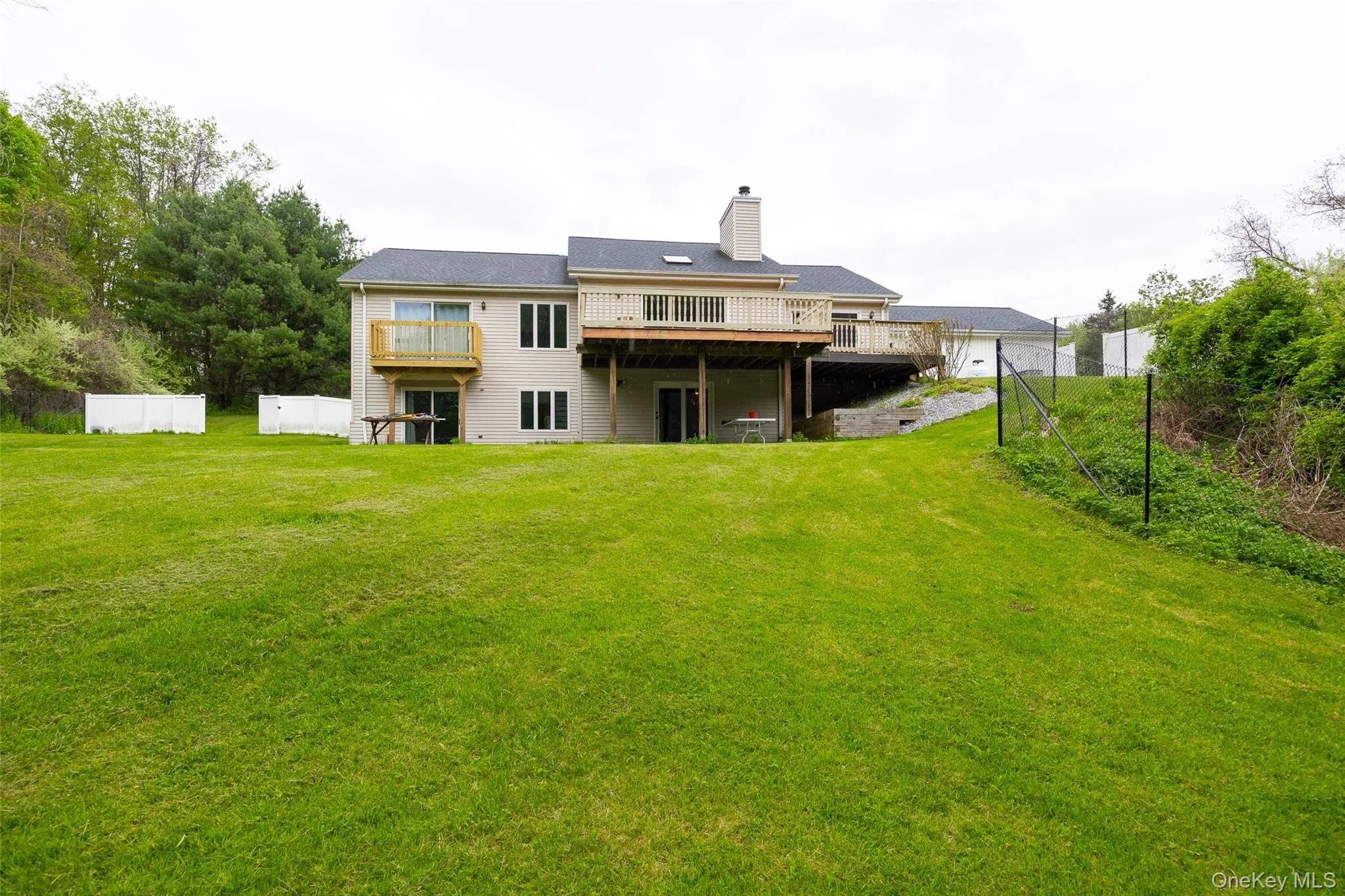 Expansive green lawn providing ample outdoor space Expansive green lawn providing ample outdoor space