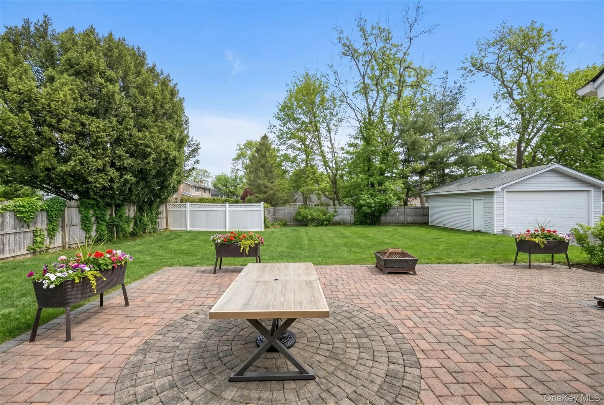 Expansive paver patio featuring a circular inlay design Expansive paver patio featuring a circular inlay design