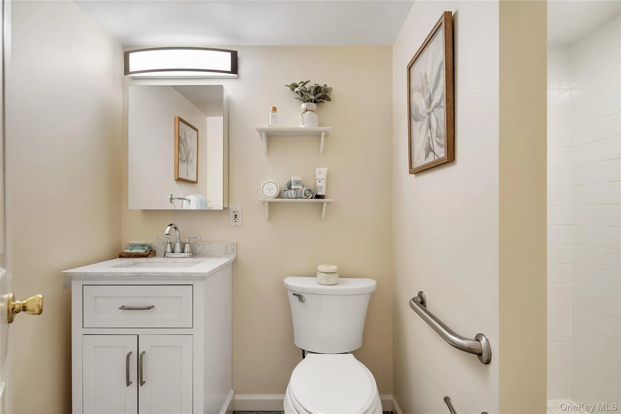 A fully renovated bathroom features a large walk-in shower and a quartz-top vanity. A fully renovated bathroom features a large walk-in shower and a quartz-top vanity.