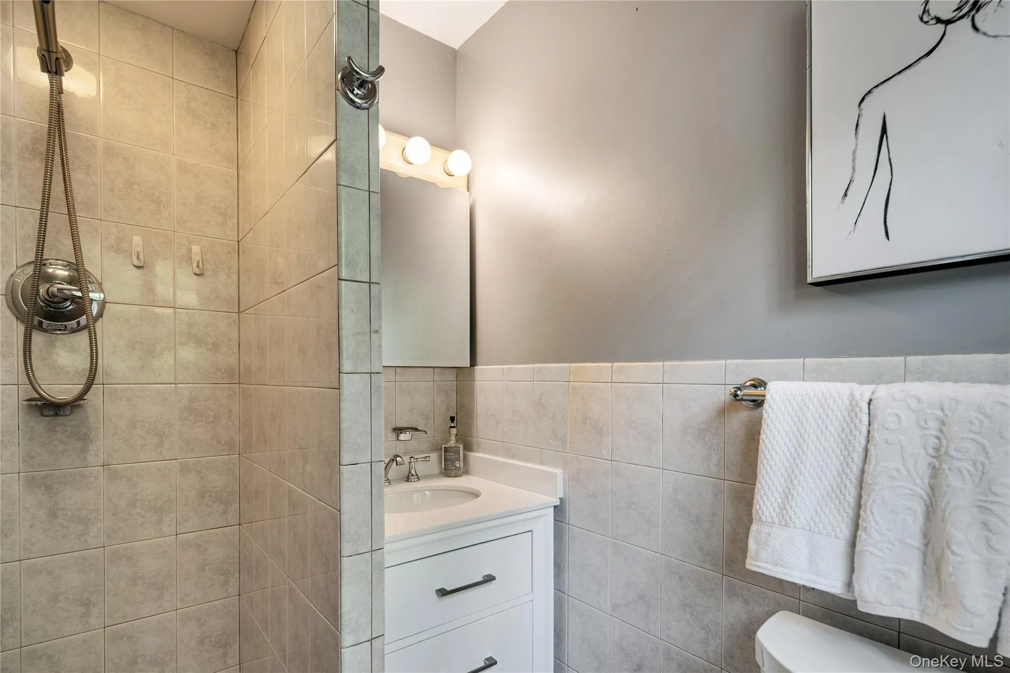 The en suite primary bathroom features a stand-up shower stall and a quartz-topped vanity. The en suite primary bathroom features a stand-up shower stall and a quartz-topped vanity.