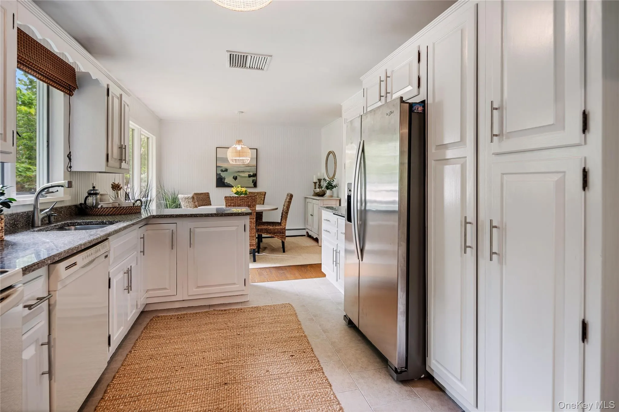 The kitchen flows seamlessly into the dining area, offering an easy layout, with a stainless steel refrigerator and multiple pantries as added bonuses. The kitchen flows seamlessly into the dining area, offering an easy layout, with a stainless steel refrigerator and multiple pantries as added bonuses.