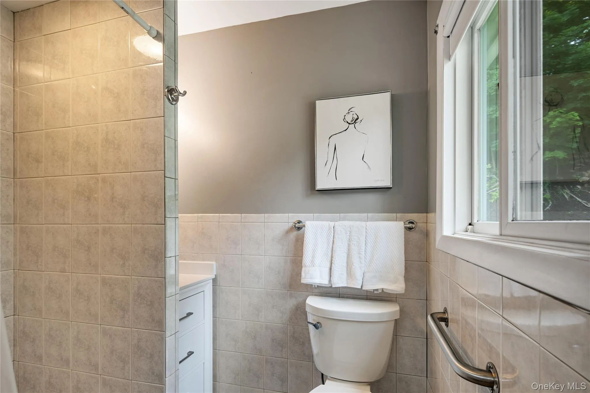 A window in the primary bath adds natural light. A window in the primary bath adds natural light.