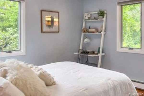 A second nicely sized bedroom on the main floor features large windows and a closet. A second nicely sized bedroom on the main floor features large windows and a closet.