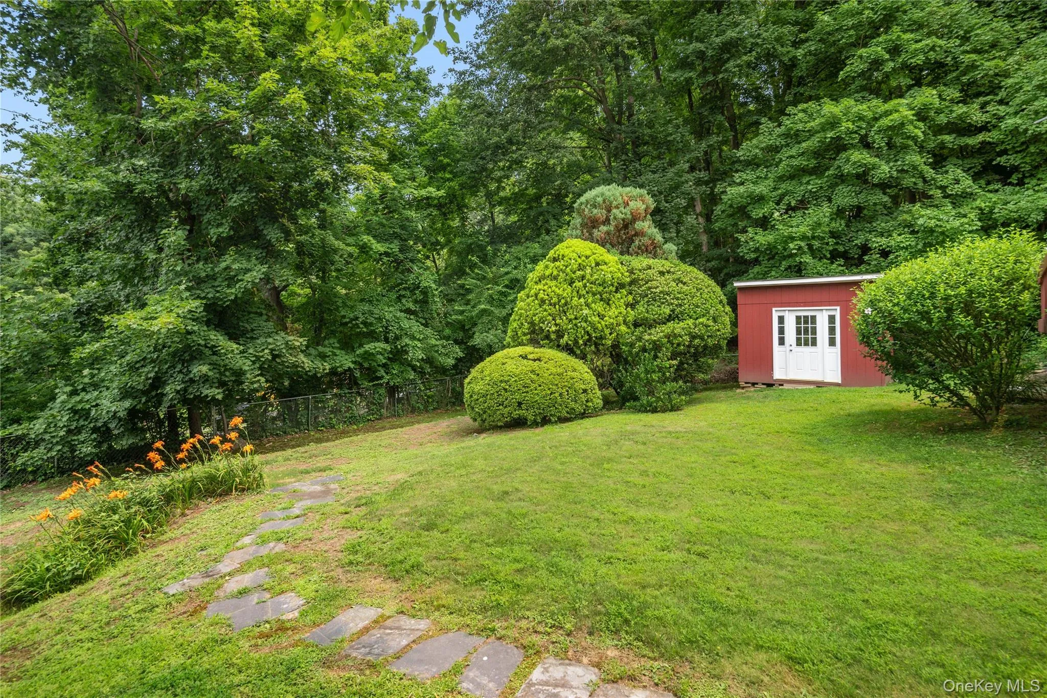 A bluest walkway guides you to the lily garden and the matching storage shed. A bluest walkway guides you to the lily garden and the matching storage shed.