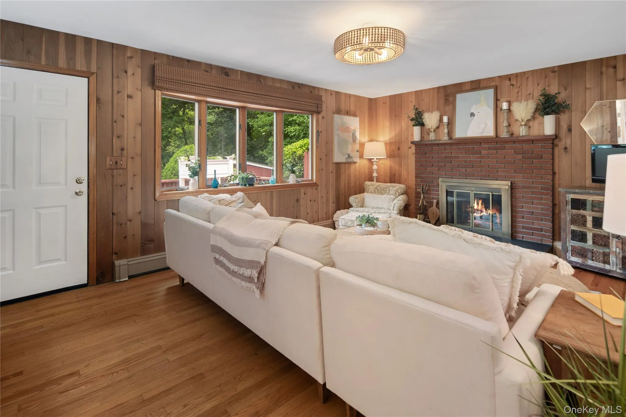 A door opens onto the wraparound deck, and a bay window brings the outdoors in. Perfect for seamless indoor-outdoor living. A door opens onto the wraparound deck, and a bay window brings the outdoors in. Perfect for seamless indoor-outdoor living.