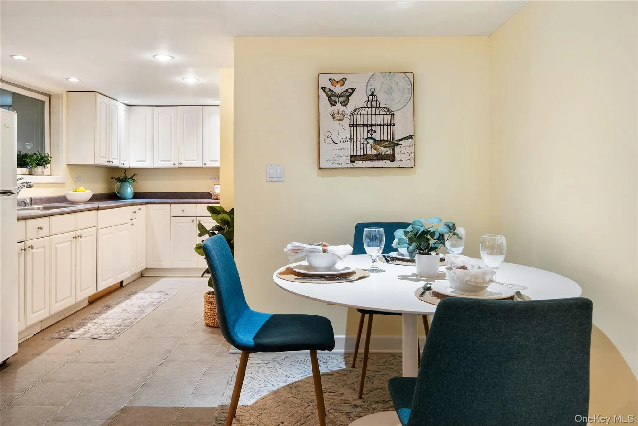 A summer kitchen with an abundance of cabinets and counter space, a window over the sink, and a dining area makes it a perfect multi-generational setup. A summer kitchen with an abundance of cabinets and counter space, a window over the sink, and a dining area makes it a perfect multi-generational setup.