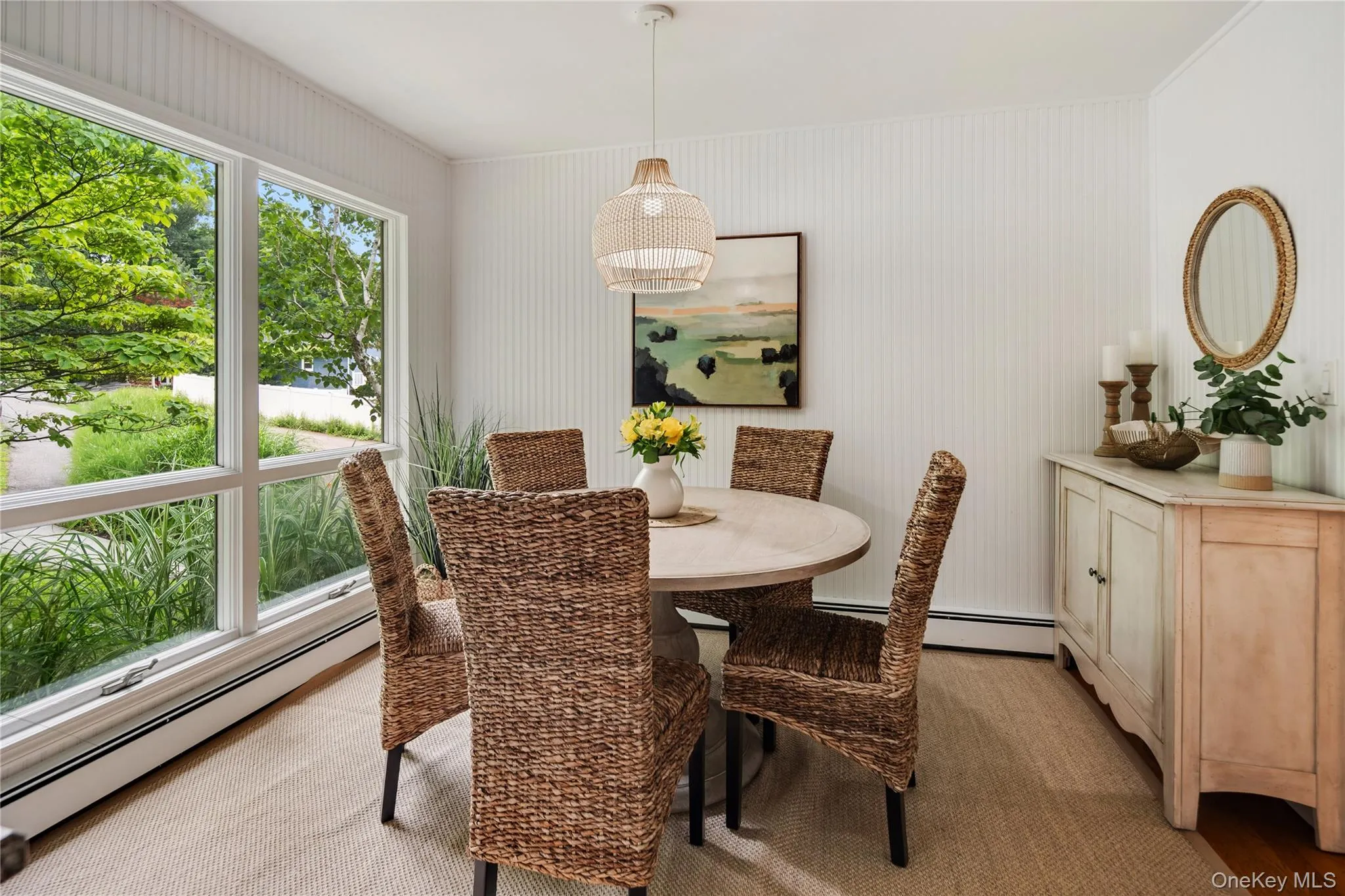A large picture window anchors the dining area, filling the space with natural sunlight and lush garden views. A large picture window anchors the dining area, filling the space with natural sunlight and lush garden views.