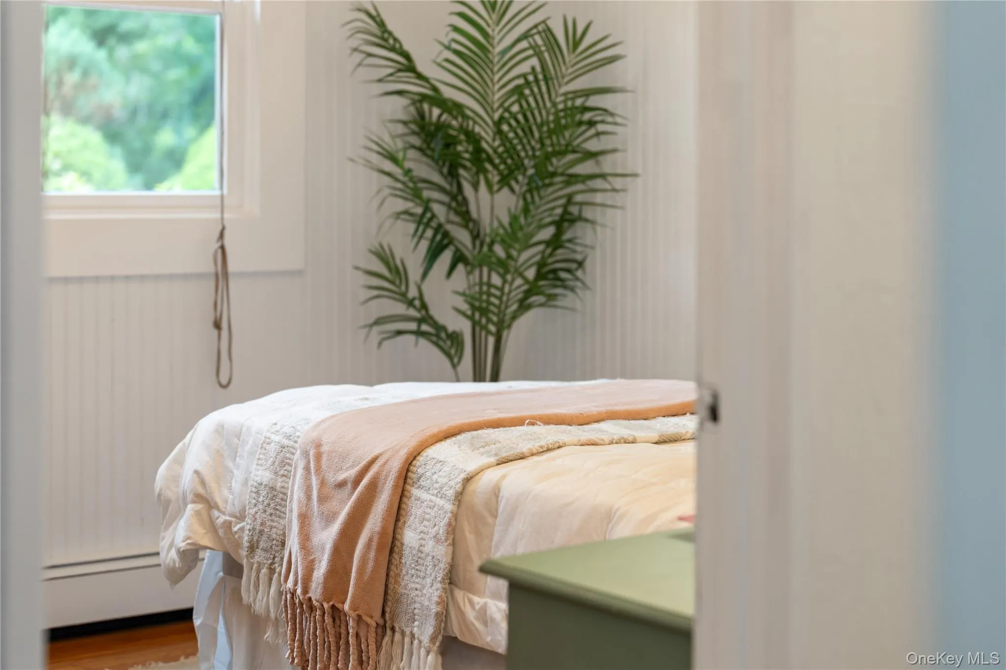 Beadboard walls add to the bedroom’s charm. Beadboard walls add to the bedroom’s charm.