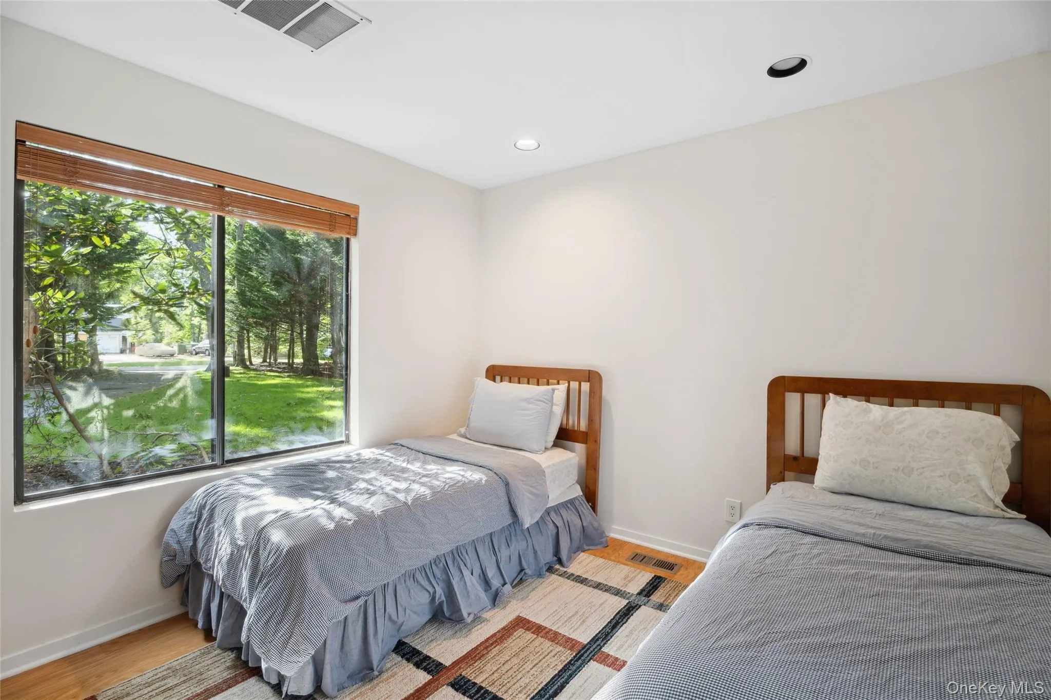 Bedroom with wood finished floors and recessed lighting Bedroom with wood finished floors and recessed lighting