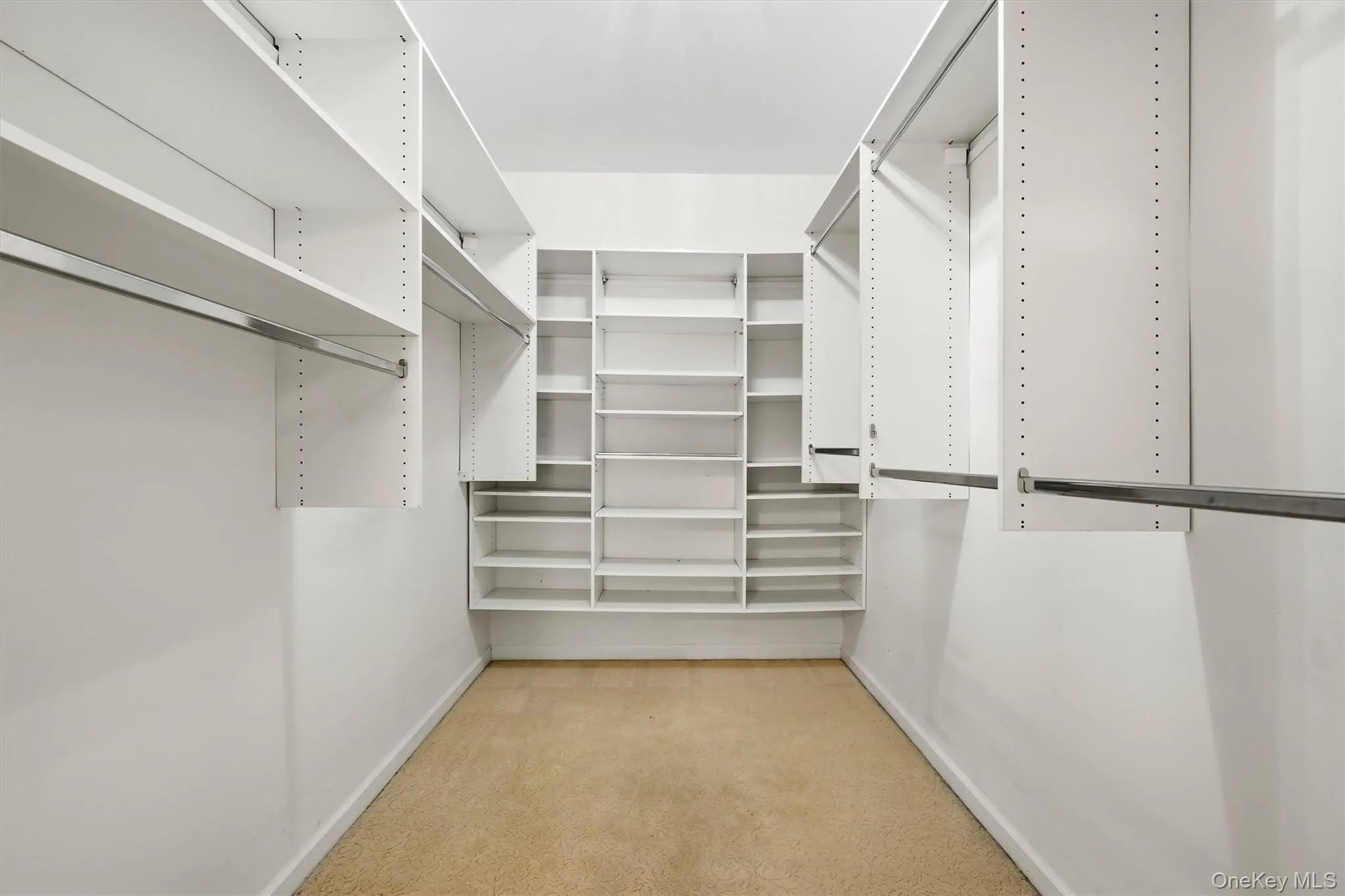 Primary bedroom's walk-in closet Primary bedroom's walk-in closet