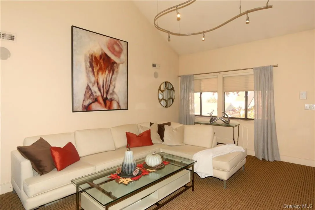 Living room with a high ceiling, a fireplace, built-ins and custom lighting Living room with a high ceiling, a fireplace, built-ins and custom lighting