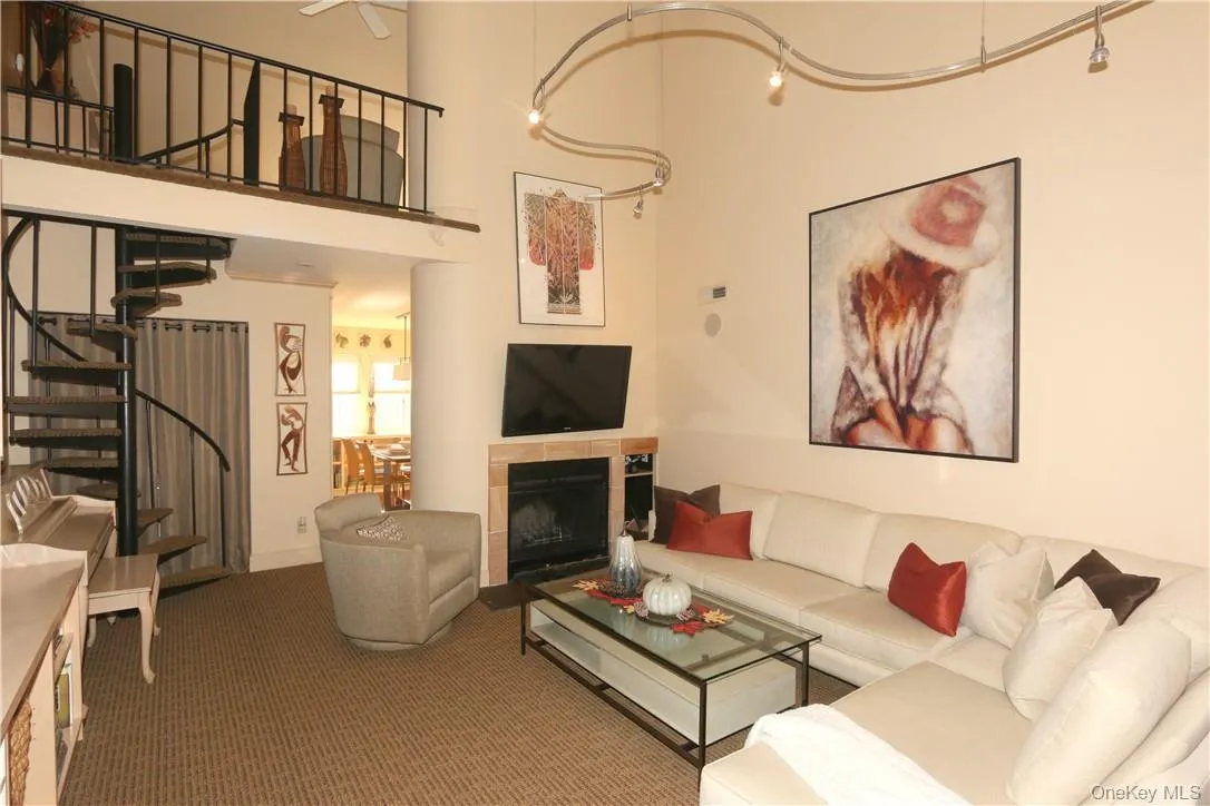 Spiral stairs to an open loft overlooking the living room Spiral stairs to an open loft overlooking the living room