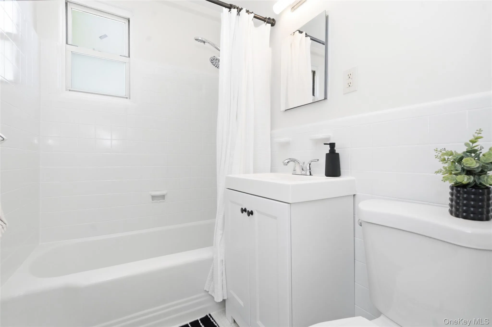 Bright, updated bathroom featuring clean finishes, a full tub/shower, and timeless appeal. Bright, updated bathroom featuring clean finishes, a full tub/shower, and timeless appeal.