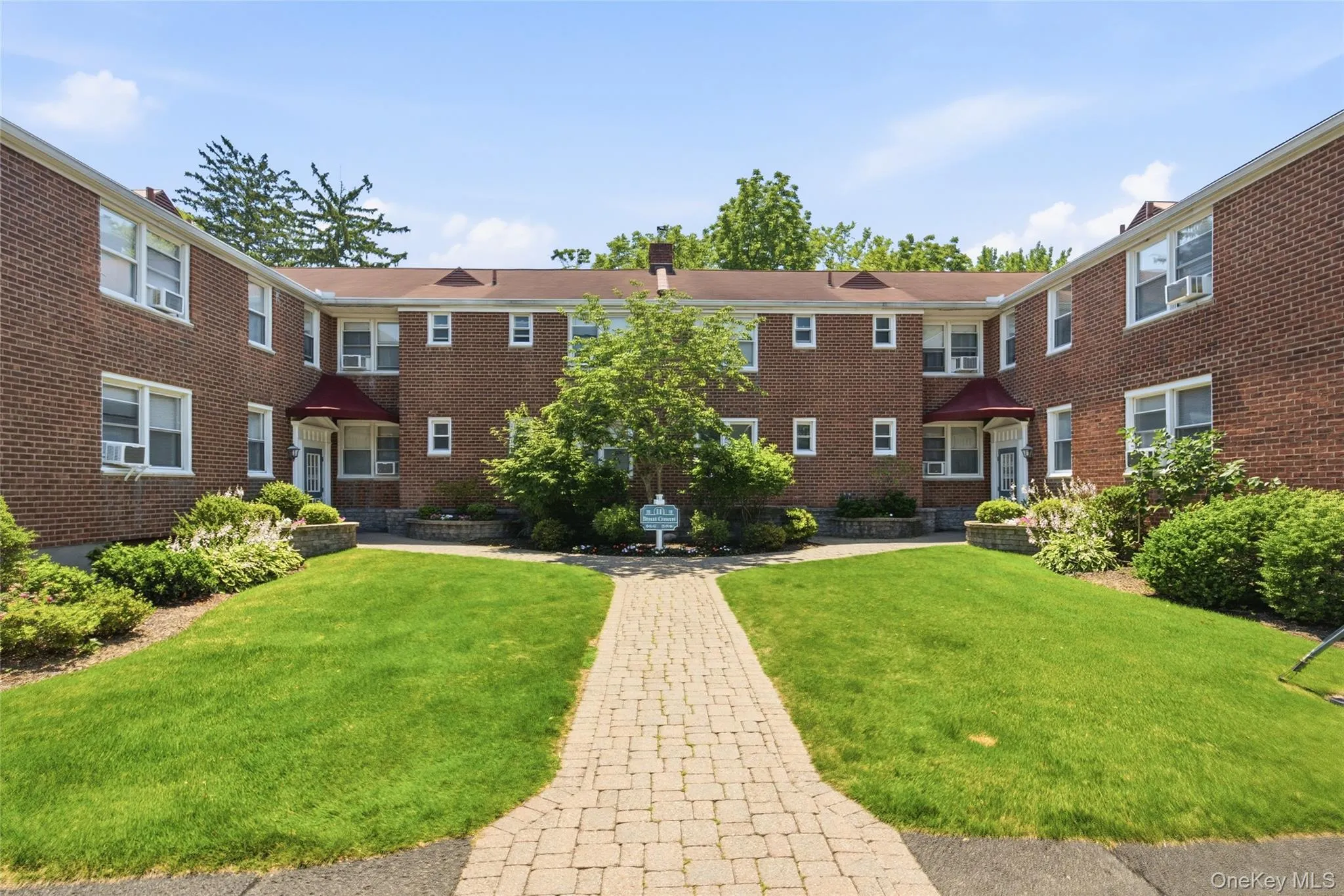 Beautifully landscaped courtyard welcomes you home with manicured lawns, mature plantings, and charming brick architecture. Beautifully landscaped courtyard welcomes you home with manicured lawns, mature plantings, and charming brick architecture.