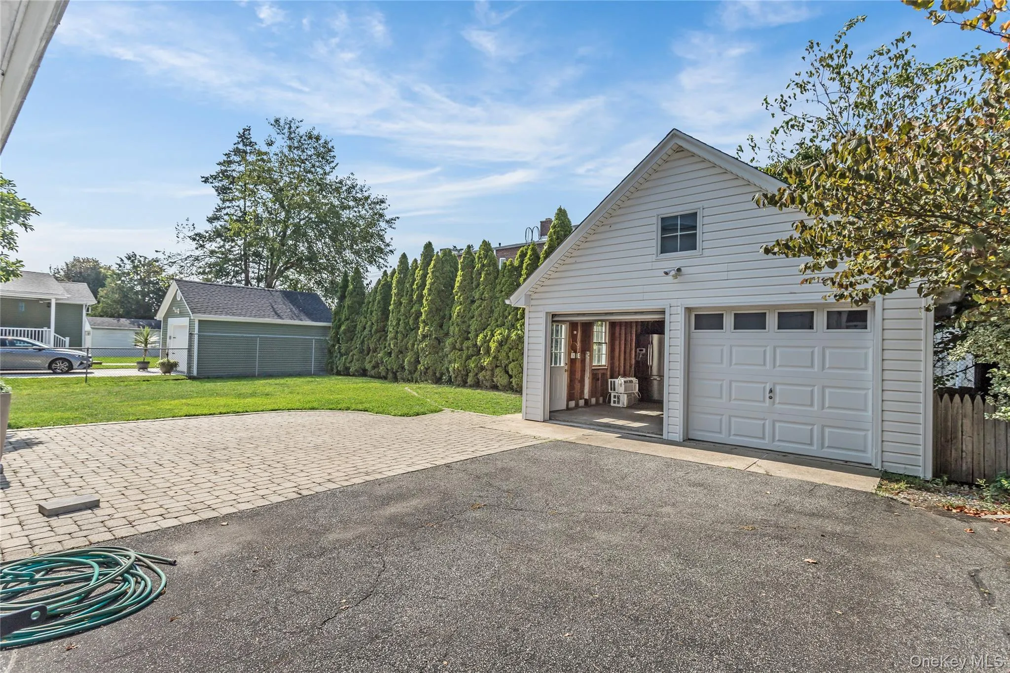 Detached garage featuring driveway Detached garage featuring driveway