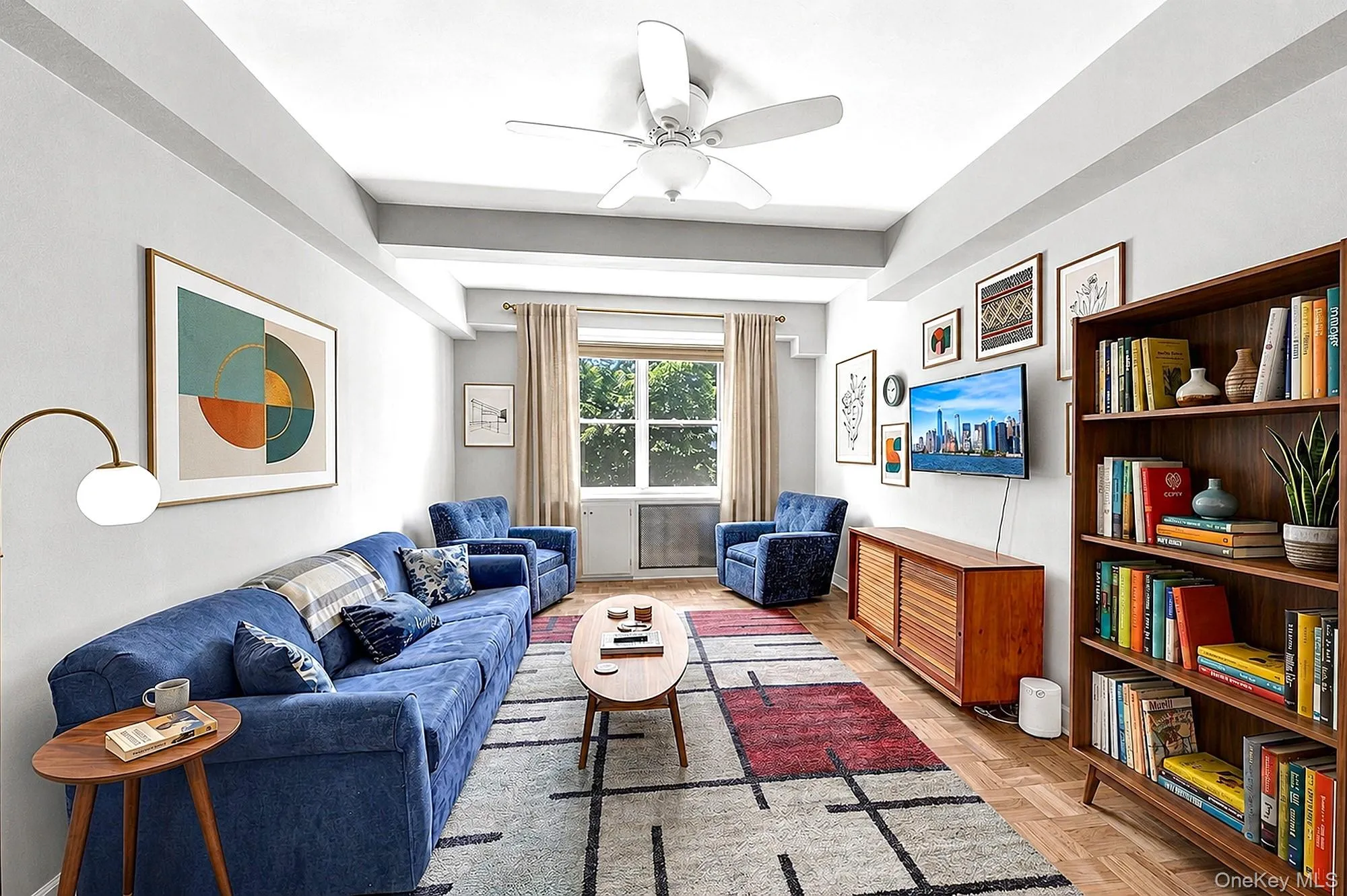 Large and spacious living room with hardwood floors, tall beamed ceilings and large windows with south-western exposure Large and spacious living room with hardwood floors, tall beamed ceilings and large windows with south-western exposure