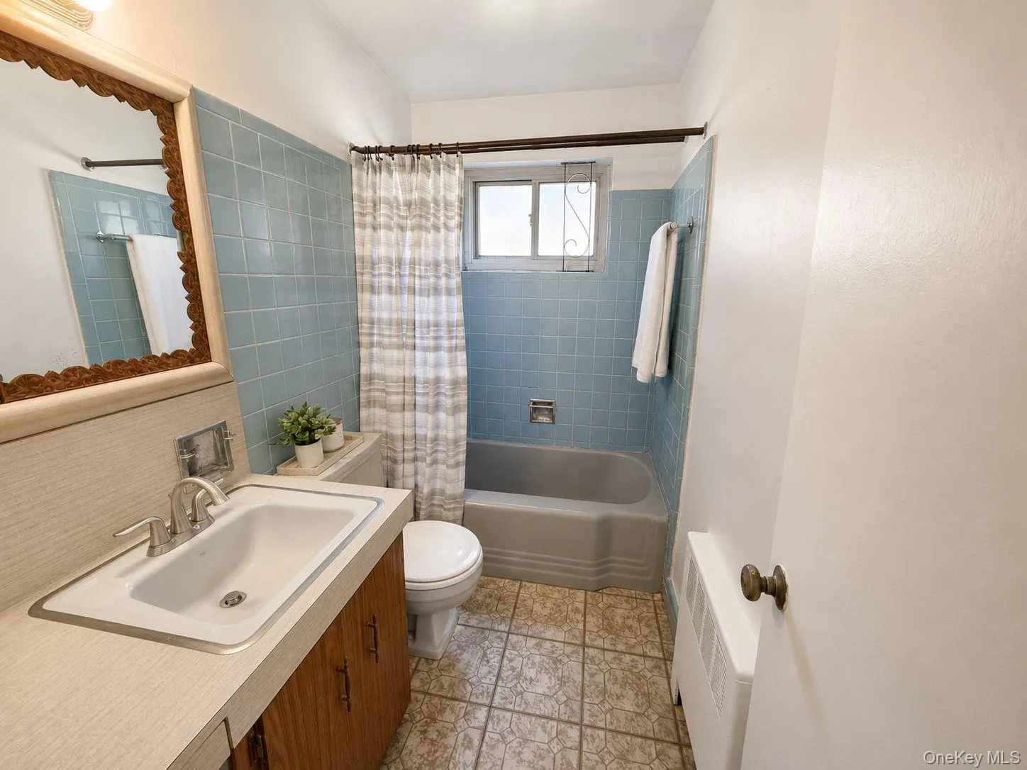 Bathroom featuring vanity, shower / tub combo with tile. Bathroom featuring vanity, shower / tub combo with tile.