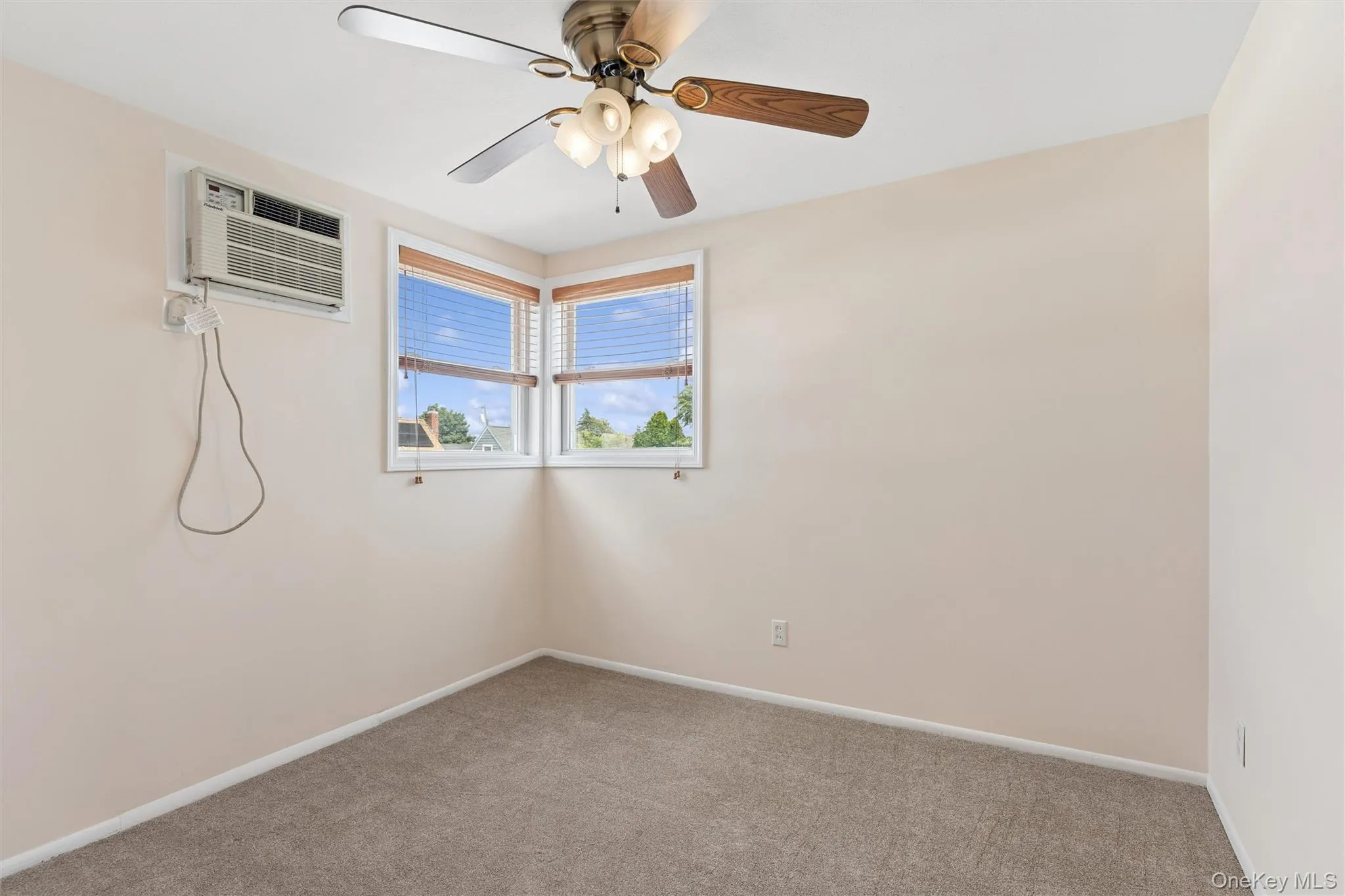 Bedroom with ceiling fan and carpet and plenty of natural light Bedroom with ceiling fan and carpet and plenty of natural light