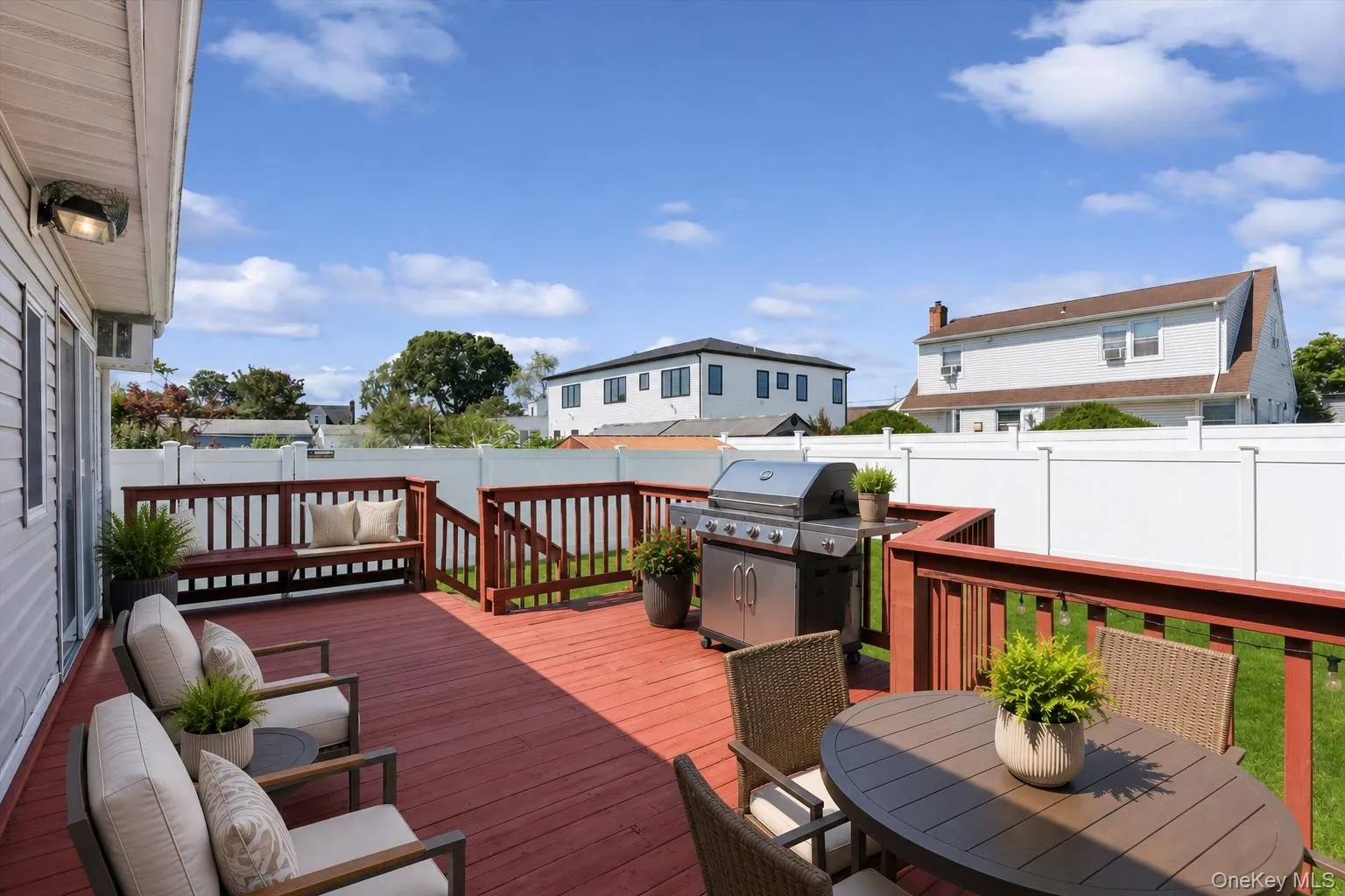 Large back deck and fully-fenced yard perfect for entertainingThis photo was virtually staged Large back deck and fully-fenced yard perfect for entertainingThis photo was virtually staged