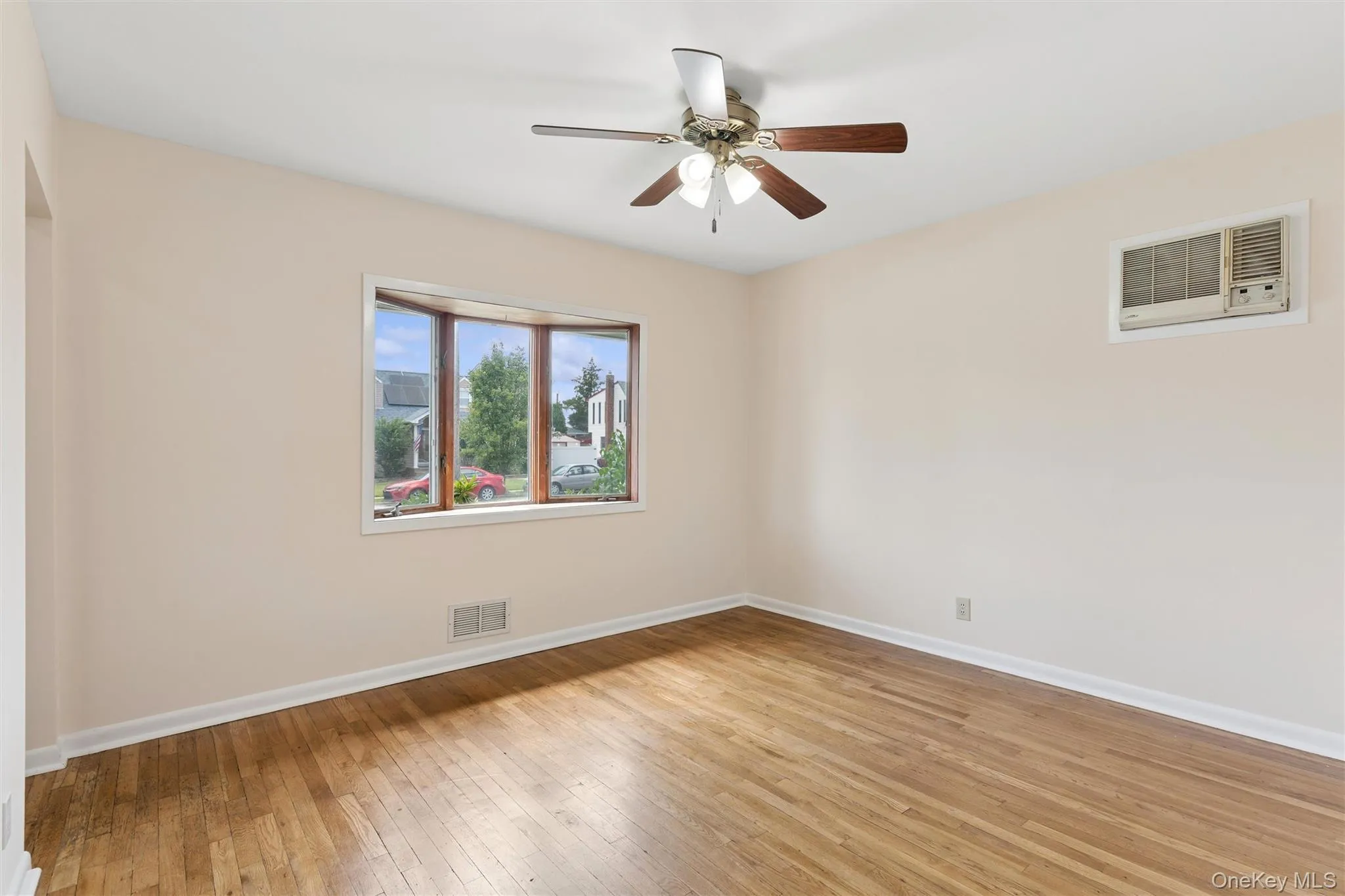 Additional room with another bay window, hardwood floors and ample natural light Additional room with another bay window, hardwood floors and ample natural light