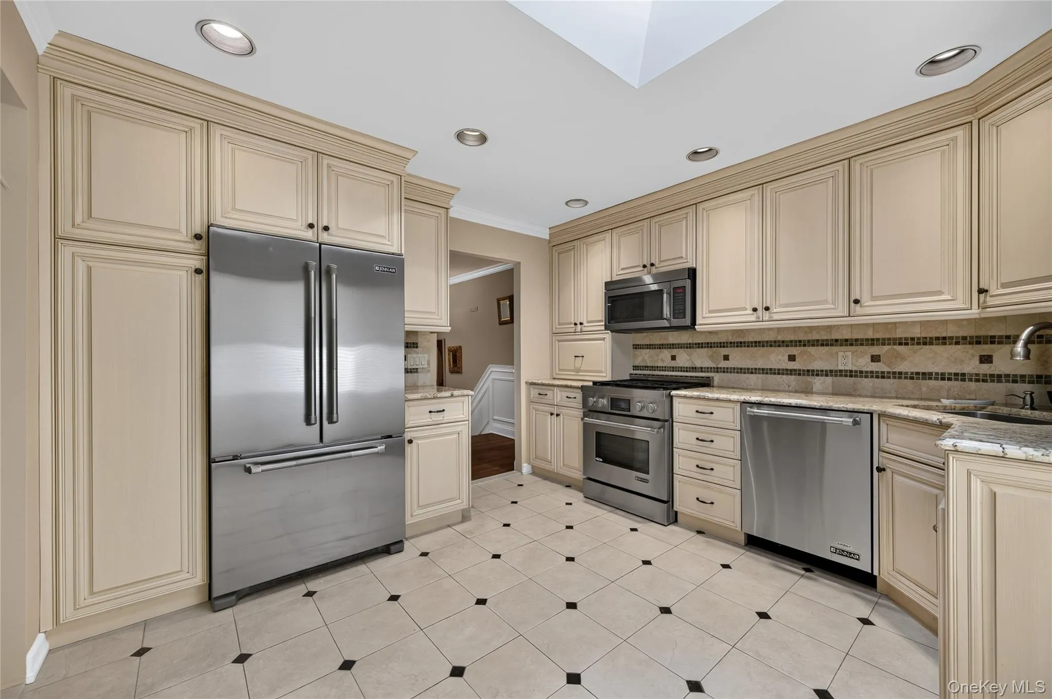 Beautifully tiled backsplash. JennAir appliances. Beautifully tiled backsplash. JennAir appliances.