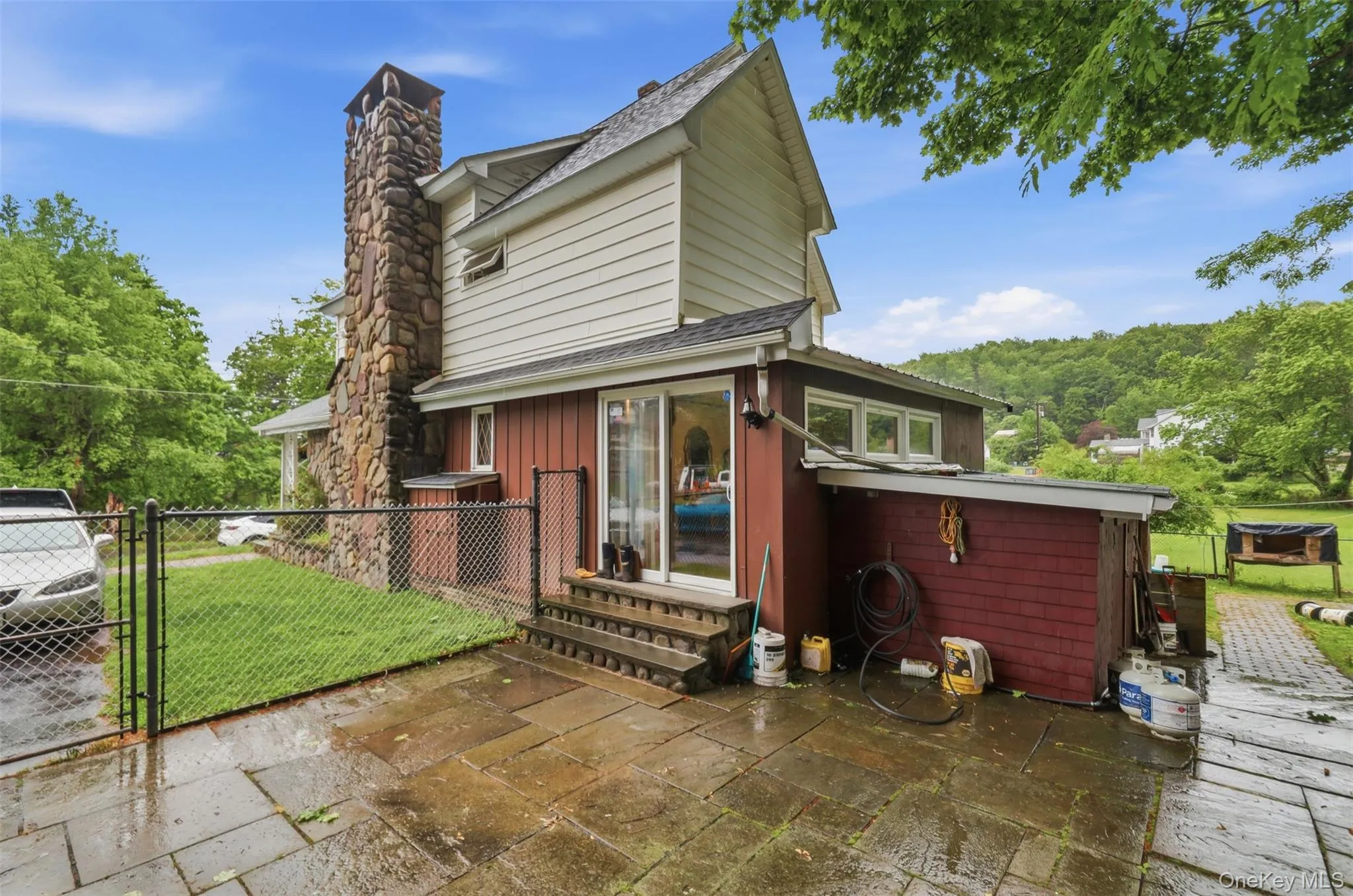Stone patio with exterior steps leading to a sliding glass door Stone patio with exterior steps leading to a sliding glass door