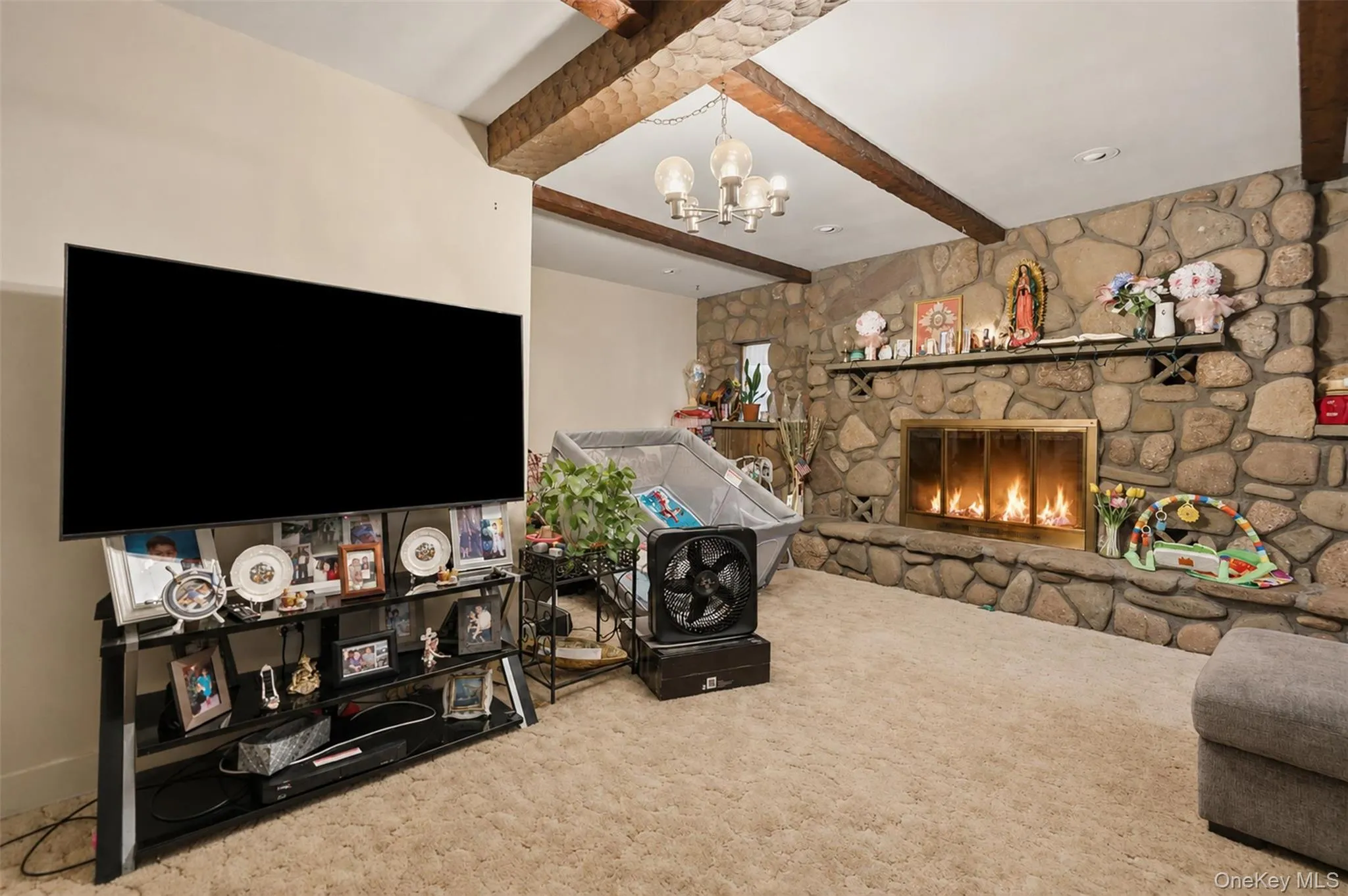 Stone-clad fireplace with a brass firebox and concrete hearth Stone-clad fireplace with a brass firebox and concrete hearth