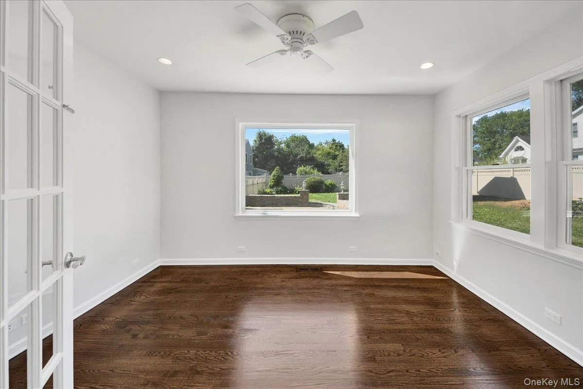 Bright interior space featuring dark wood-finish flooring Bright interior space featuring dark wood-finish flooring