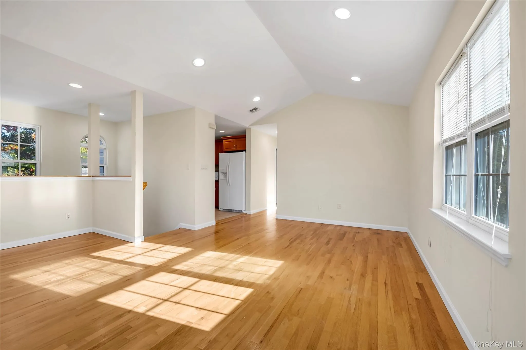 Living Room wth view of entry staircase and hallway leading to kitchen Living Room wth view of entry staircase and hallway leading to kitchen