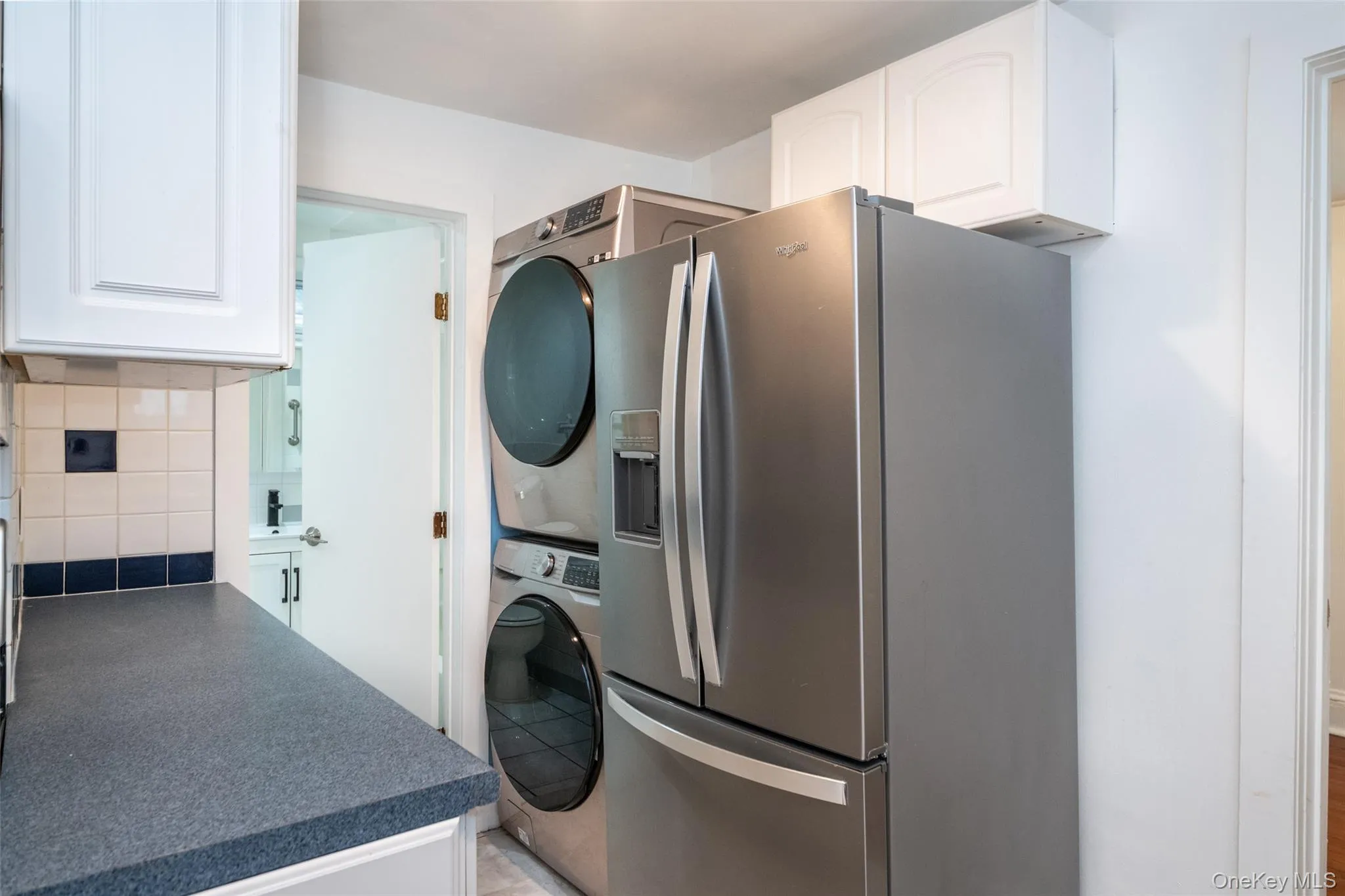 Kitchen with washer & dryer looking into the bathroom Kitchen with washer & dryer looking into the bathroom