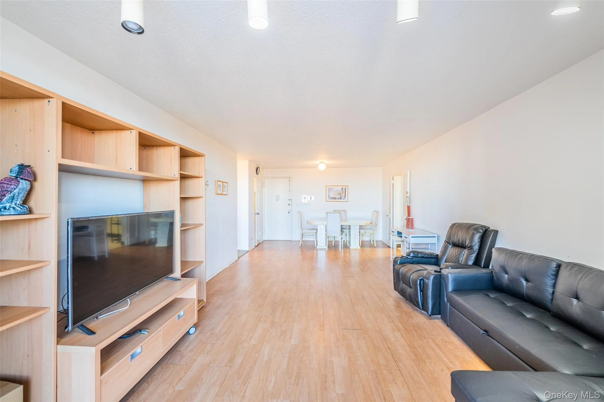 Living area with light wood-style floors Living area with light wood-style floors