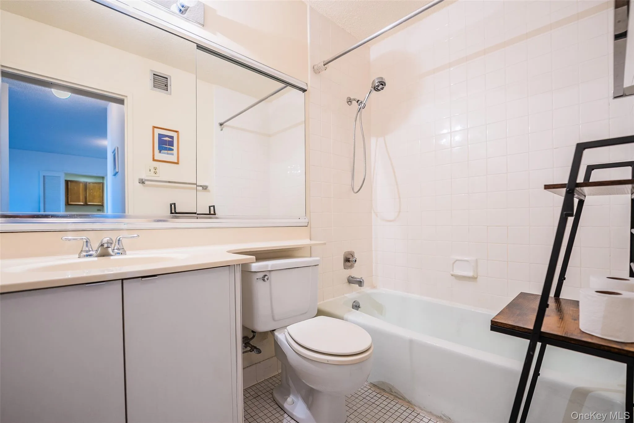 Bathroom featuring shower / bathtub combination, vanity, and tile patterned floors Bathroom featuring shower / bathtub combination, vanity, and tile patterned floors