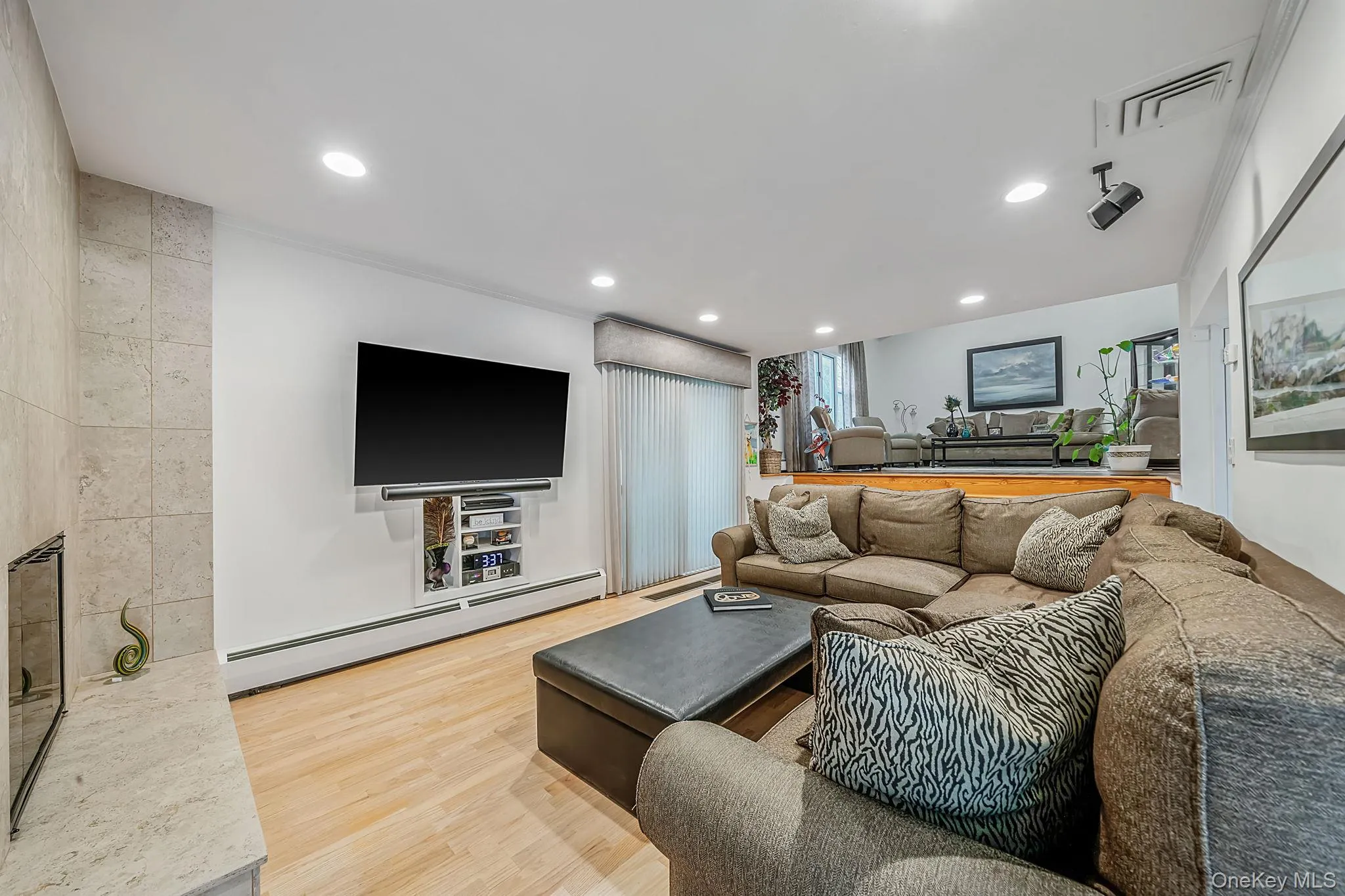 Spacious Den with wood burning fireplace and engineered wood flooring Spacious Den with wood burning fireplace and engineered wood flooring