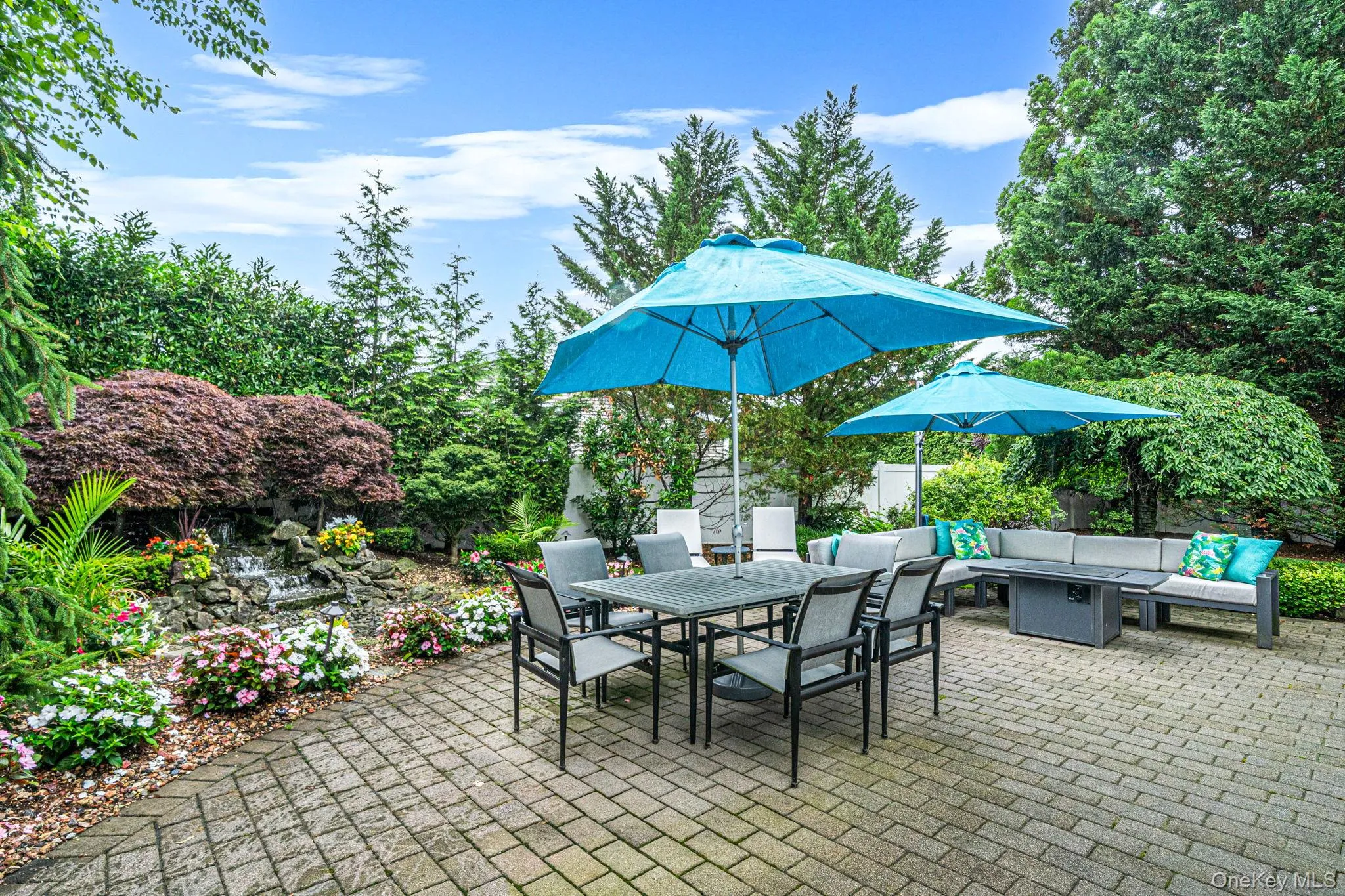 Backyard with large brick paver patio and water feature Backyard with large brick paver patio and water feature
