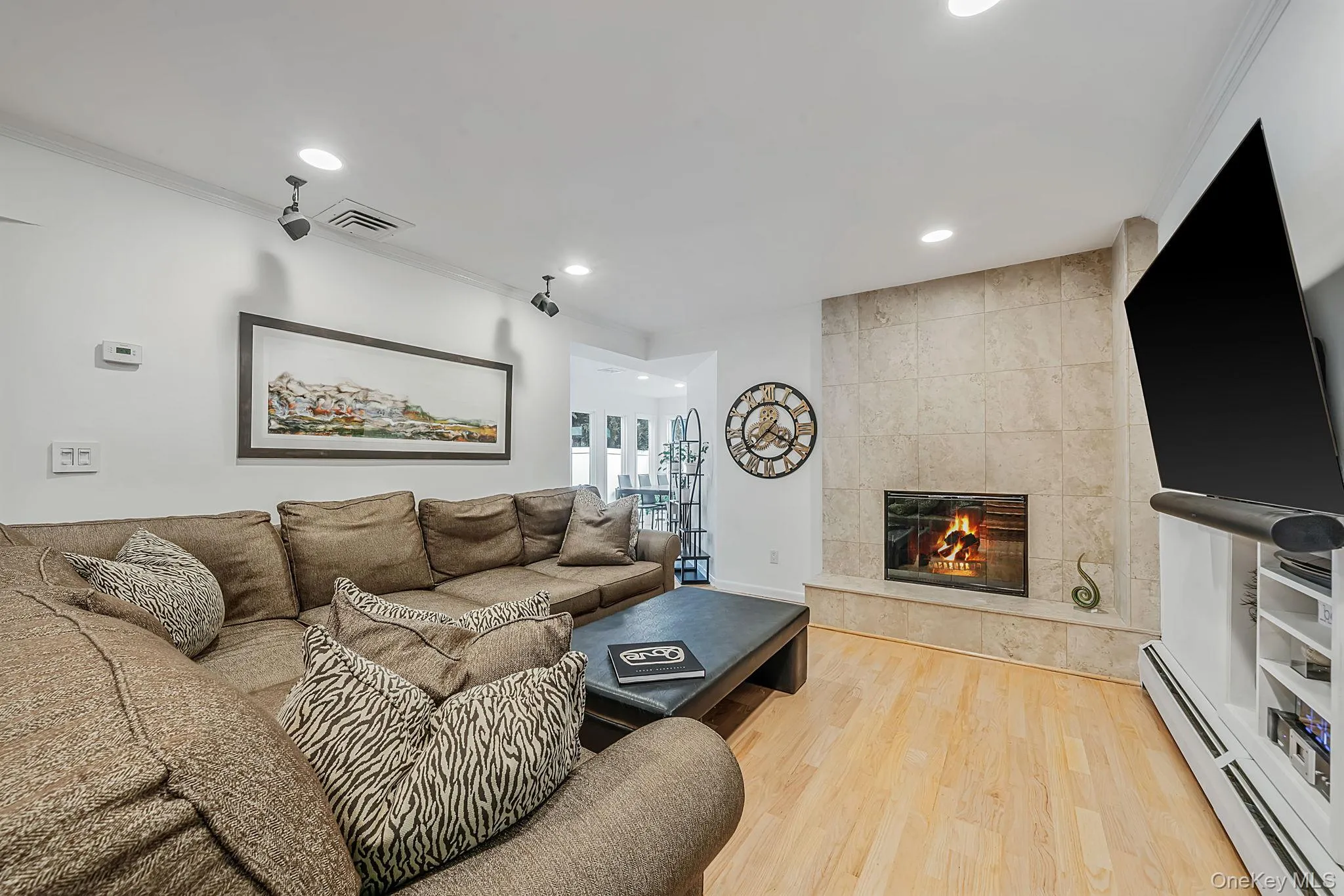 Spacious Den with wood burning fireplace and engineered wood flooring Spacious Den with wood burning fireplace and engineered wood flooring