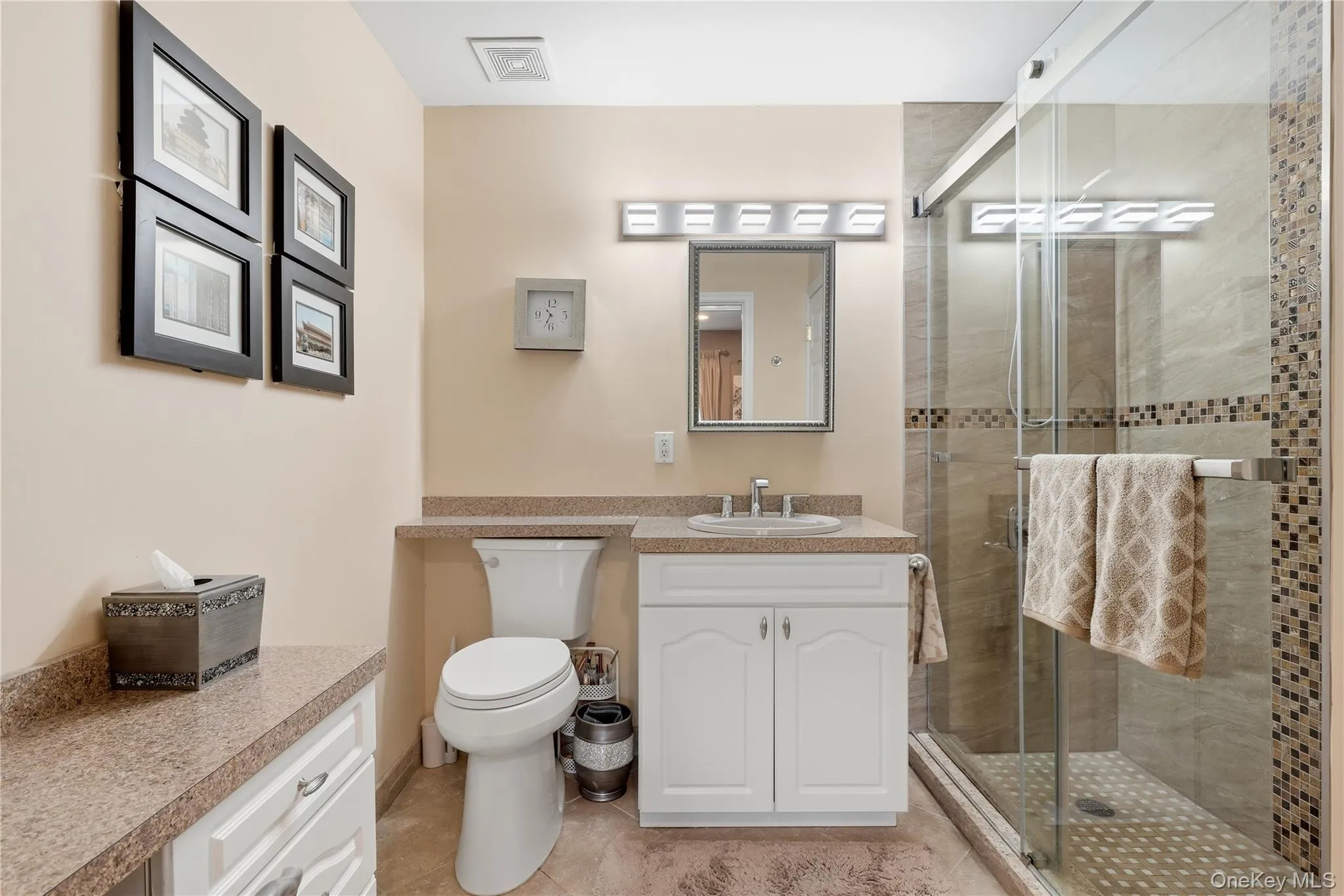 Primary Full Bath with Glass Shower doors and Makeup Vanity with Seating Primary Full Bath with Glass Shower doors and Makeup Vanity with Seating