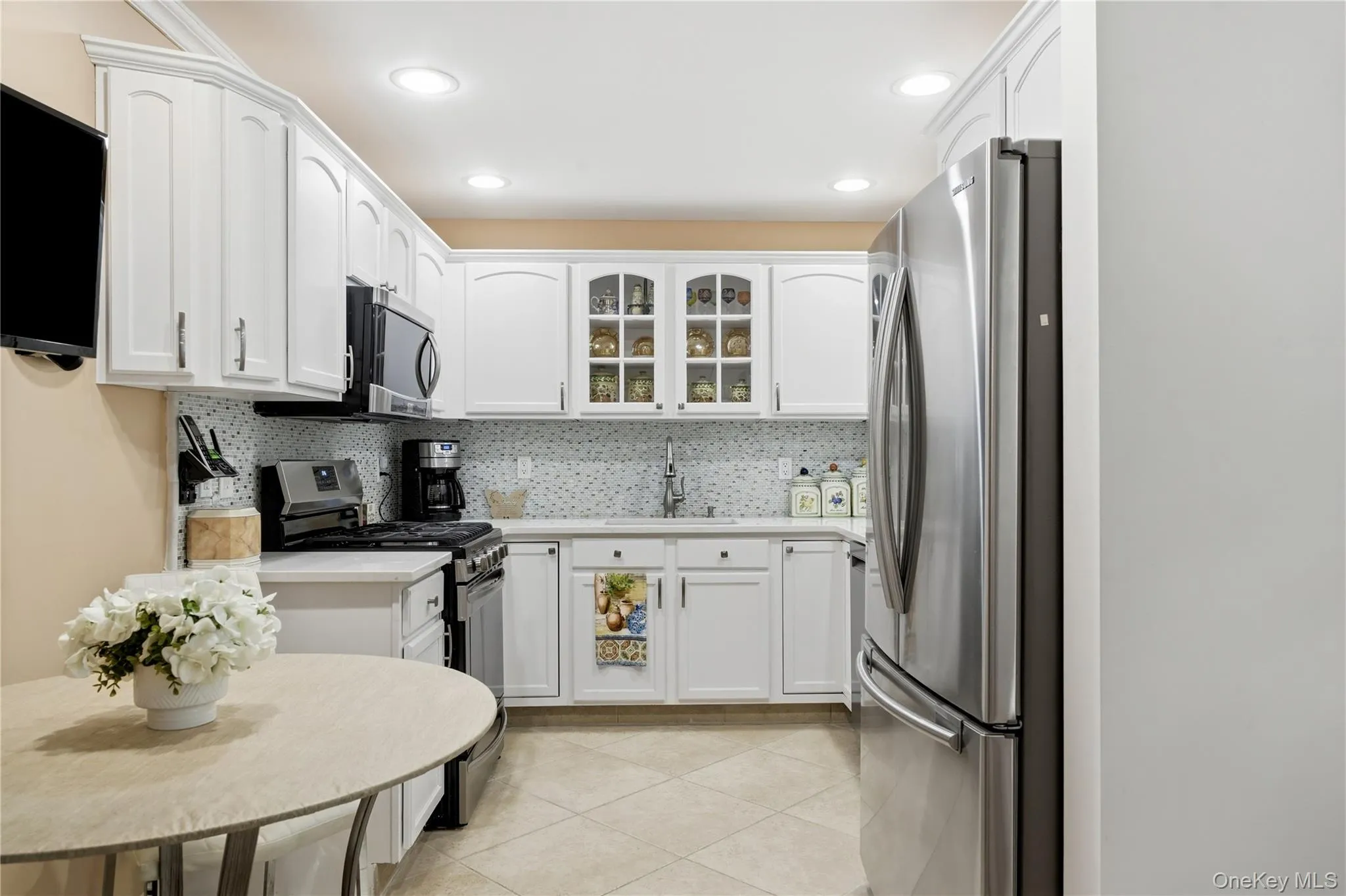 White Cabinetry & Glass Inlays with Quartz Counters White Cabinetry & Glass Inlays with Quartz Counters
