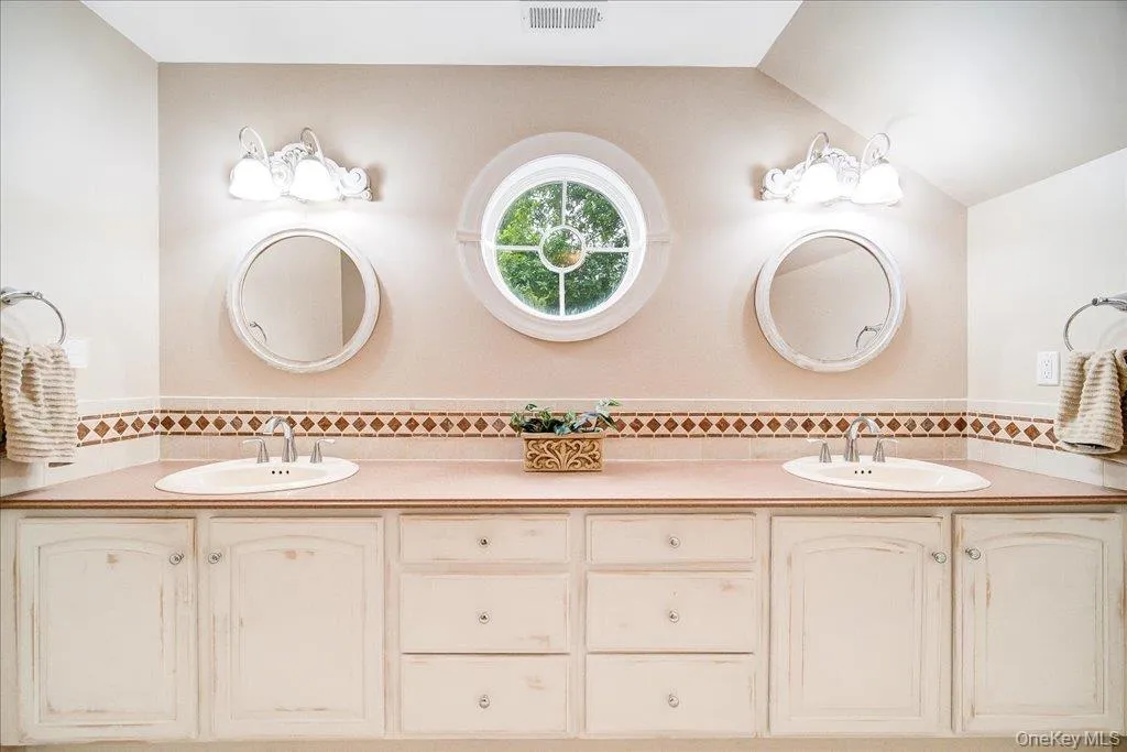 Massive double sink vanity in this oversized and light-filled primary bath. Massive double sink vanity in this oversized and light-filled primary bath.