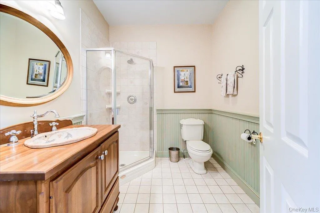 A first floor full bath with double doors from the front room and the main hall offering convenience for both owners and guests. A first floor full bath with double doors from the front room and the main hall offering convenience for both owners and guests.
