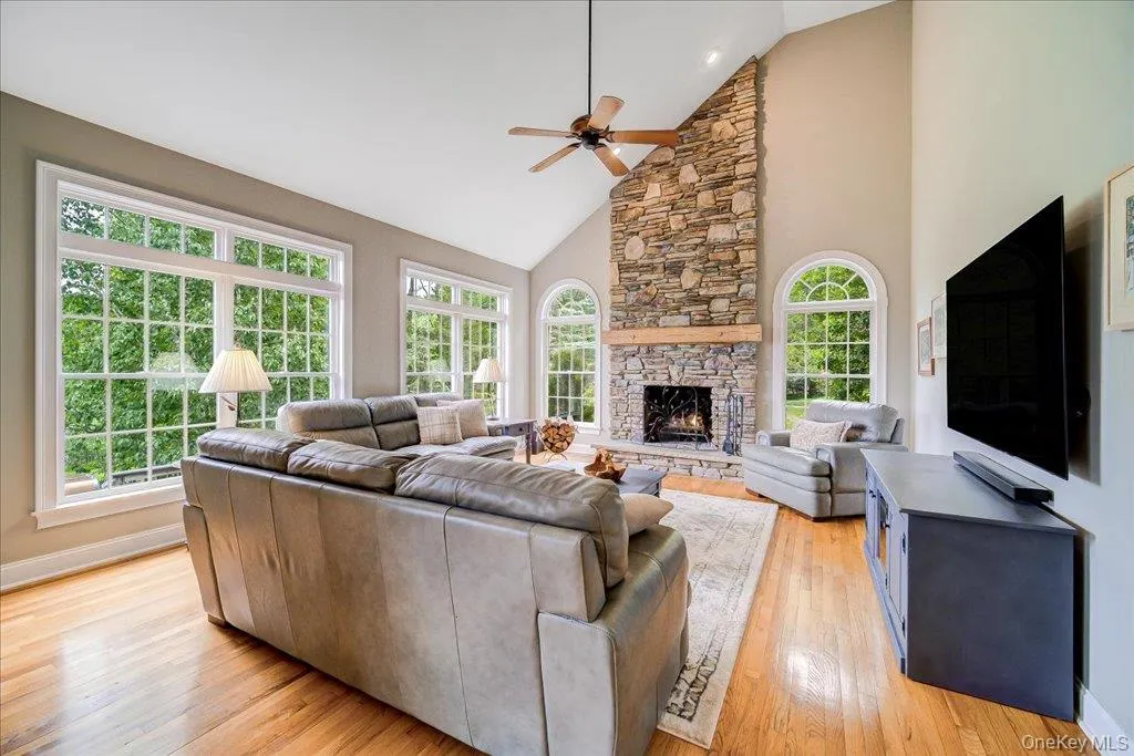 Amazing floor to ceiling stacked stone real wood burning fireplace is there focal point of this large family room. Tons of large windows bring in the natural light and the view of the pond! Amazing floor to ceiling stacked stone real wood burning fireplace is there focal point of this large family room. Tons of large windows bring in the natural light and the view of the pond!
